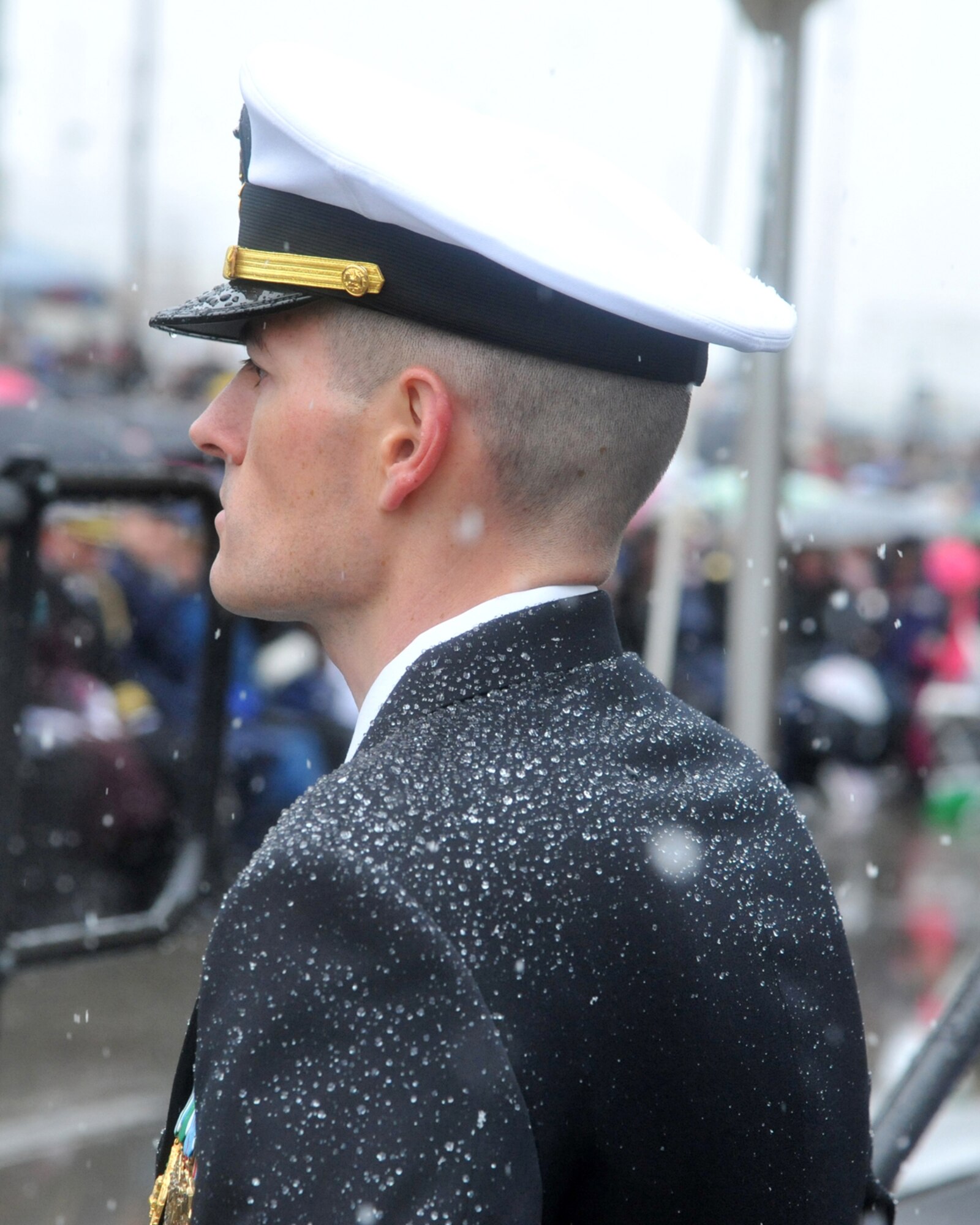 JOINT BASE ELMENDORF-RICHARDSON, Alaska – A crew member of the Navy’s newest ship, the United States Ship Anchorage, braves the snowy conditions during the ship’s commissioning ceremony at the Port of Anchorage May 4. The amphibious transport dock ship is the second Navy vessel to bare the name of Alaska’s largest city. (U.S. Air Force photo/Senior Airman Blake Mize)