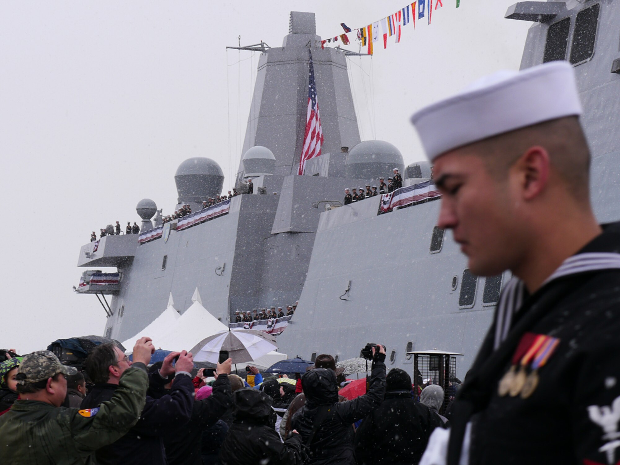 ANCHORAGE, Alaska -- Guests, Sailors and Marines at the commissioning ceremony for the San-Antonio-class amphibious transport dock USS Anchorages (LPD 23) gather at the ship during a snow-covered ceremony at the Port of Anchorage May 4. Anchorage is the seventh San Antonio-class LPD and was deliver to the U.S. Navy in September 2012. The amphibious transport dock ship is the second Navy vessel to bare the name of Alaska's largest city. (U.S. Air Force photo/Maj. Joseph Coslett)