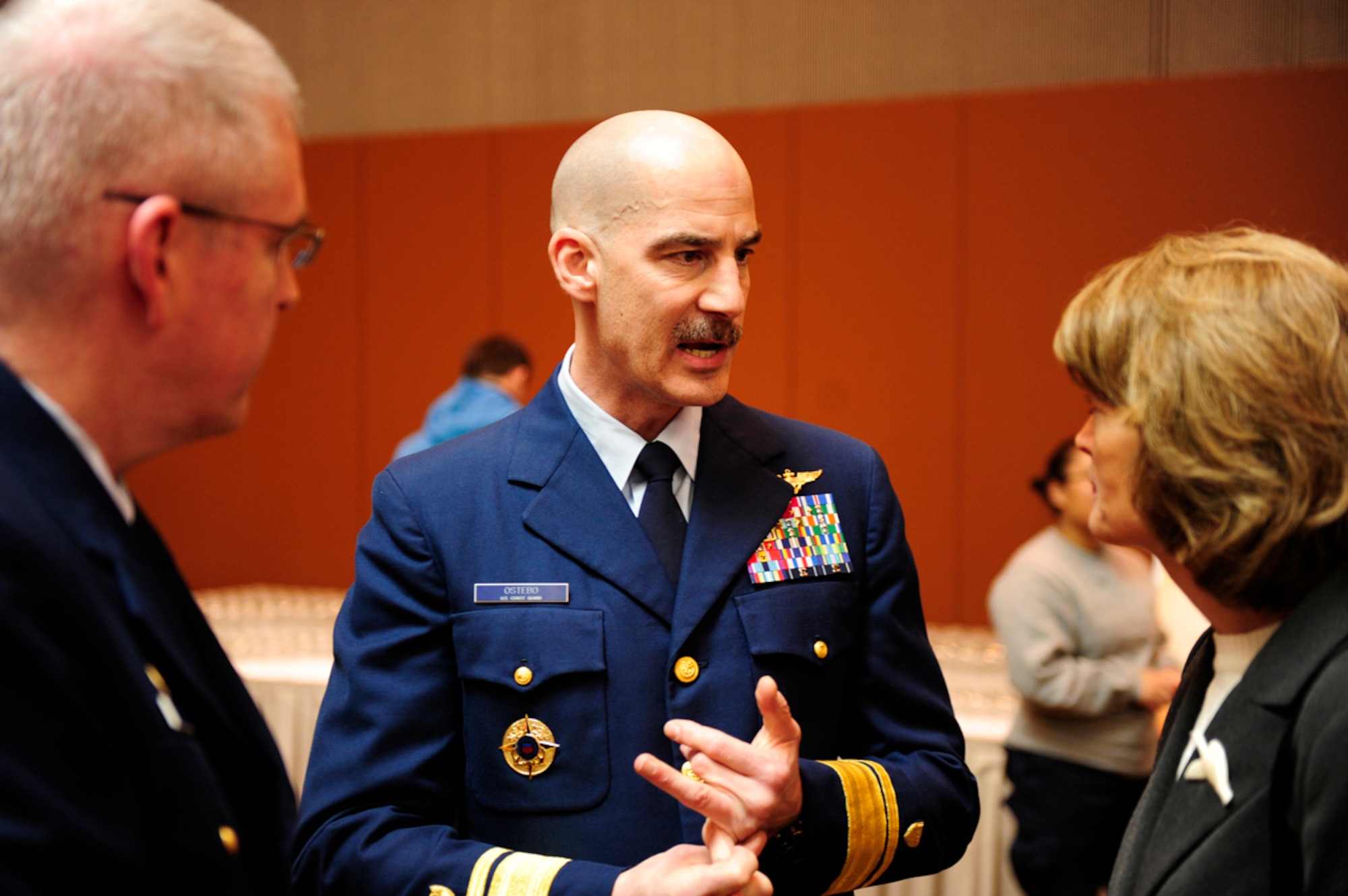 Rear Adm. Thomas Ostebo, commander, Coast Guard 17th District, talks with Alaska Sen. Lisa Murkowski at the post-commissioning ceremony reception for the guests and crew who attended the commissioning of the USS Anchorage at the Port of Anchorage, Alaska, May 4, 2013. Ostebo and Murkowski discussed the multi-mission capabilities of the USS Anchorage and how the Coast Guard often uses a single platform to accomplish many of the service's statutory missions across Alaska and the Arctic. (U.S. Coast Guard photo/Petty Officer 1st Class David Mosley)
