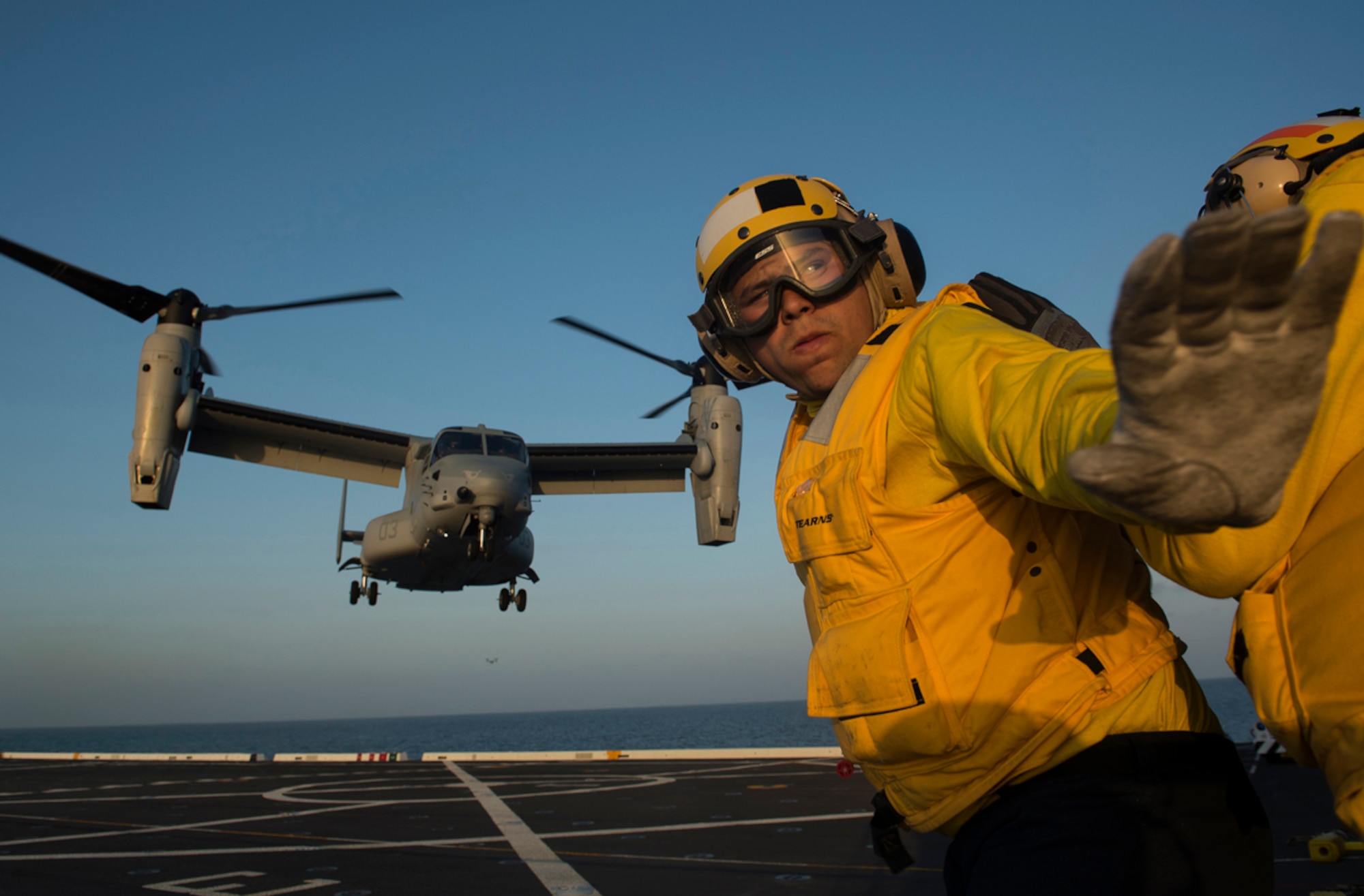 Pacific Ocean (April 23, 2013) Aviation Boatswain's Mate (Handling) 2nd Class Wilmer Ramos, assigned to San Antonio-class amphibious transport dock ship USS San Diego (LPD 22), turns to check the departure airspace as he directs the launch of an MV-22 Osprey assigned to Marine Medium Tiltrotor Squadron (VMM) 163 on the flight deck of Pre-Commissioning Unit (PCU) Anchorage (LPD 23). Air Department Sailors from San Diego are aboard Anchorage earning qualifications and maintaining proficiency while the ship is underway. Anchorage is currently en route to its namesake city of Anchorage, Alaska for its commissioning ceremony May 4. (U.S. Navy photo/Petty Officer 1st Class James R. Evans)