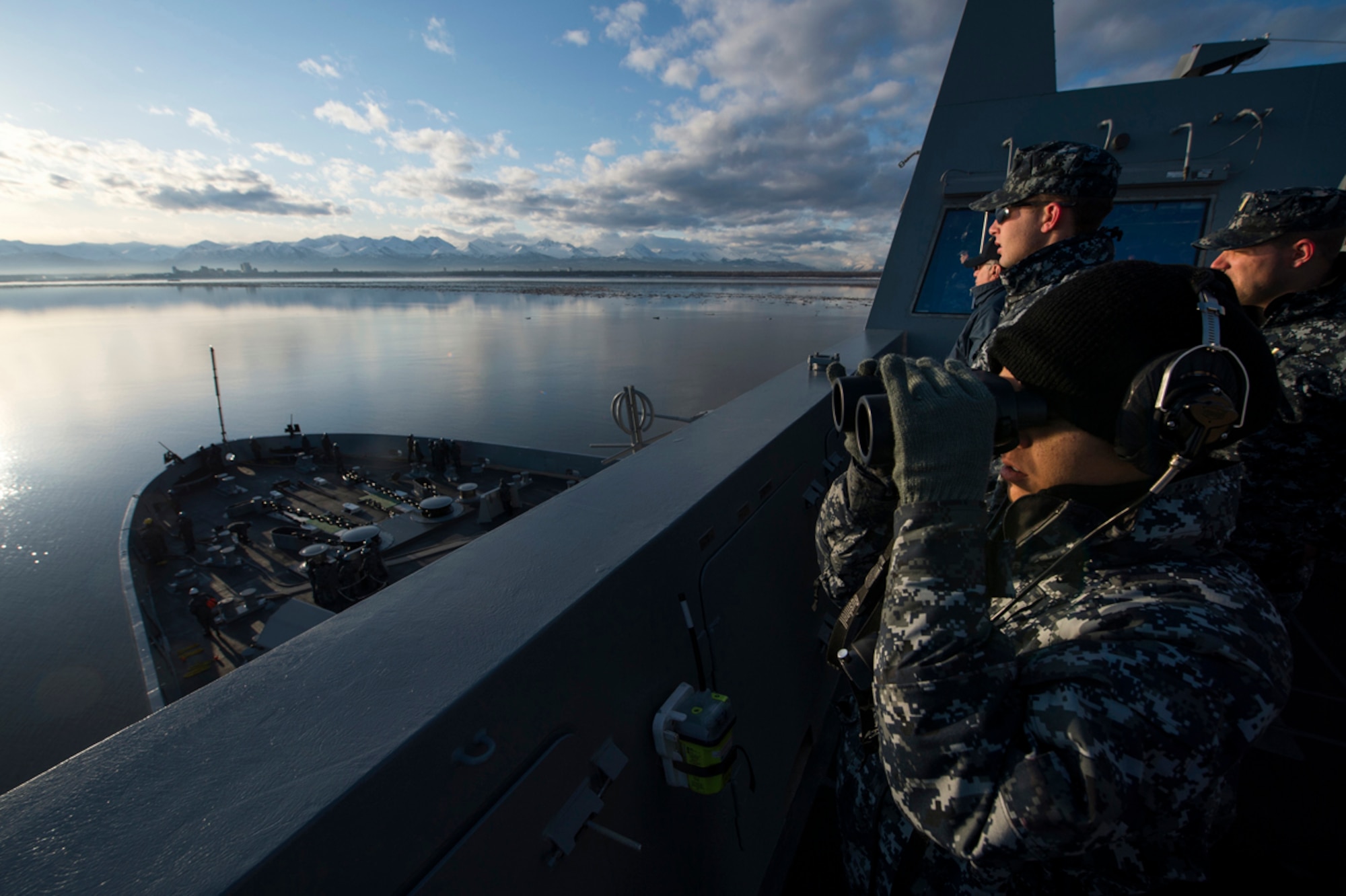 COOK INLET, Alaska (May 1, 2013) Sailors watch from the port bridge wing as the San Antonio-class amphibious transport dock ship Pre-Commissioning Unit (PCU) Anchorage (LPD 23) approaches the city of Anchorage, Alaska. Anchorage is en route to its namesake city for its commissioning ceremony May 4. (U.S. Navy photo/Petty Officer 1st Class James R. Evans)