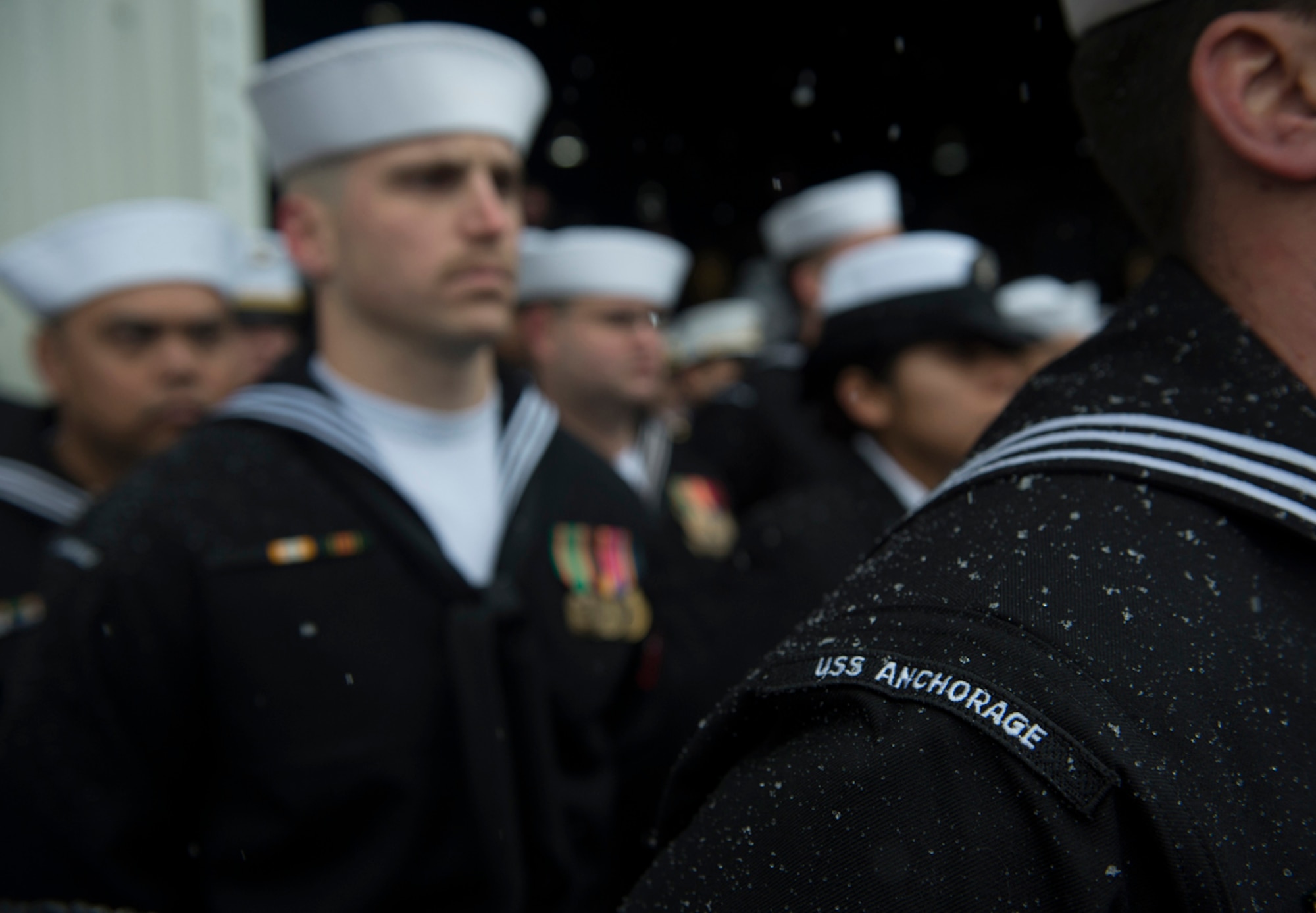 Snow falls on crew members as they wait to bring the ship to life during the commissioning ceremony of the San Antonio-class amphibious transport dock ship USS Anchorage (LPD 23) at the Port of Anchorage Saturday. More than 4,000 people gathered to witness the ship’s commissioning in its namesake city of Anchorage. Anchorage, the seventh San Antonio-class amphibious transport dock ship, is the second ship to be named for the city. (U.S. Navy photo/Petty Officer 1st Class James R. Evans)