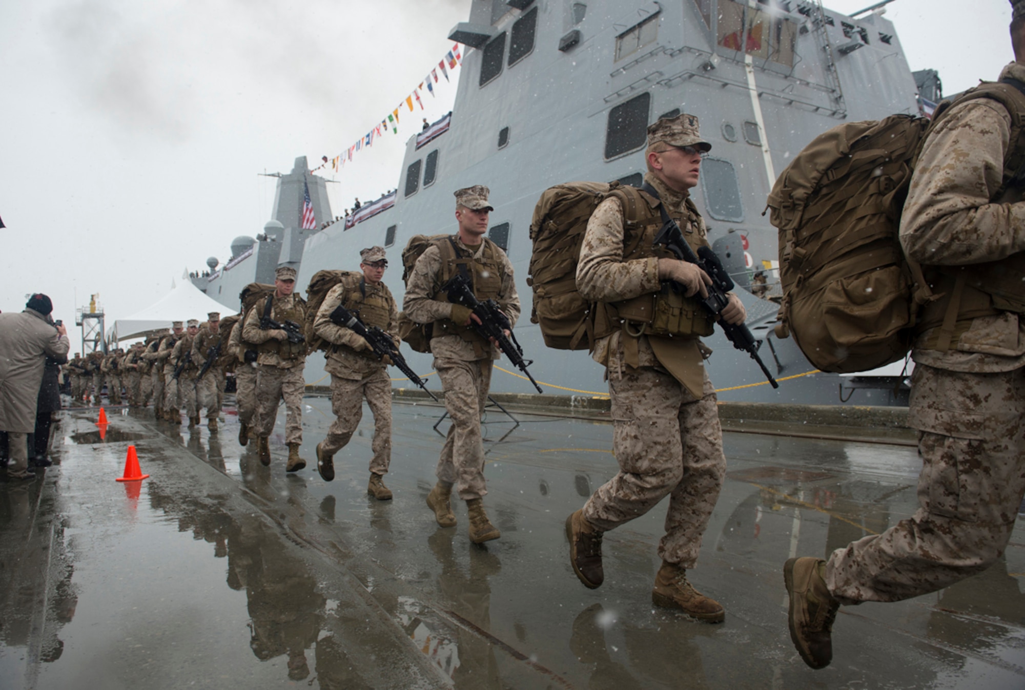 ANCHORAGE, Alaska (May 4, 2013) Marines assigned to Task Force Denali run to bring the ship to life during the commissioning of the San Antonio-class amphibious transport dock ship USS Anchorage (LPD 23) at the Port of Anchorage. More than 4,000 people gathered to witness the ship's commissioning in its namesake city of Anchorage, Alaska. Anchorage, the seventh San Antonio-class LPD, is the second ship to be named for the city and the first U.S. Navy ship to be commissioned in Alaska. Designed to transport a Marine embarked landing force, the USS Anchorage is operated by 28 Navy officers, 332 enlisted Sailors, and includes three liaison Marines. The Marine force comprises 66 officers and 633 enlisted Marines, with a surge capacity of 800. (U.S. Navy photo/Petty Officer 1st Class James R. Evans)
