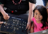 Damon Hall-Kaneakua’s sister, right, smiles for the camera while her brother operates the controls of an explosive ordnance disposal robot at the EOD mobile truck from the 647th Civil Engineer Squadron, 15th Wing, Joint Base Pearl Harbor-Hickam, Hawaii, May 3, 2013. Hall-Kaneakua was a guest of the 15th Wing as part of the Pilot for a Day program that gives children with serious or chronic conditions a special day and a break from whatever challenges they may face. (U.S. Air Force photo/Tech. Sgt. Phyllis E. Keith)