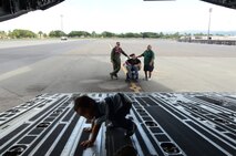 Damon Hall-Kaneakua’s younger brother, center, explores the aft ramp of a C-17 Globemaster III, while in the background from left, Capt. Rush H. Taylor, coordinator of the Pilot for a Day program, talks with Hall-Kaneakua and Hall-Kaneakua’s grandfather at Joint Base Pearl Harbor-Hickam, Hawaii, May 3, 2013. Hall-Kaneakua was a guest of the 15th Wing as part of the Pilot for a Day program that gives children with serious or chronic conditions a special day and a break from whatever challenges they may face. (U.S. Air Force photo by Tech. Sgt. Phyllis E. Keith)