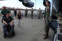 Damon Hall-Kaneakua, in wheelchair, listens to Senior Airman Alek Joga, 535th Airlift Squadron  loadmaster, explains the capabilities of the C-17 Globemaster III‘s large aft ramp to load rolling stock, like tanks, trucks, trailers, and palletized cargo, on the flightline at Joint Base Pearl Harbor-Hickam, Hawaii, May 3, 2013. Hall-Kaneakua and his family were guests of the 15th Wing as part of the Pilot for a Day program, a partnership with Kapiolani Hospital that gives children with serious or chronic conditions a special day and a break from whatever challenges they may face. (U.S. Air Force photo/Tech. Sgt. Phyllis E. Keith)