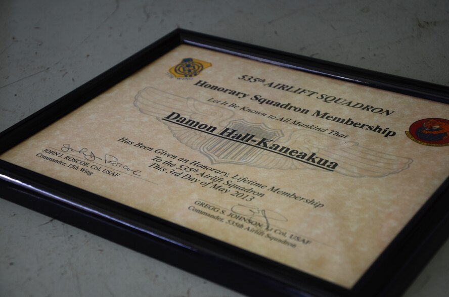 An “Honorary Squadron Membership” certificate was presented to Damon Hall-Kaneakua of Kaneohe, Hawaii, by Lt. Col. Gregg S. Johnson, commander of the 535th Airlift Squadron at the C-17 Squadron Operations building, Joint Base Pearl Harbor-Hickam, Hawaii, May 3, 2013. Hall-Kaneakua and family members were guests of the 15th Wing as part of the Pilot for a Day program, a partnership with Kapiolani Hospital that gives children with serious or chronic conditions a special day and a break from whatever challenges they may face. (U.S. Air Force photo by Tech. Sgt. Phyllis E. Keith)