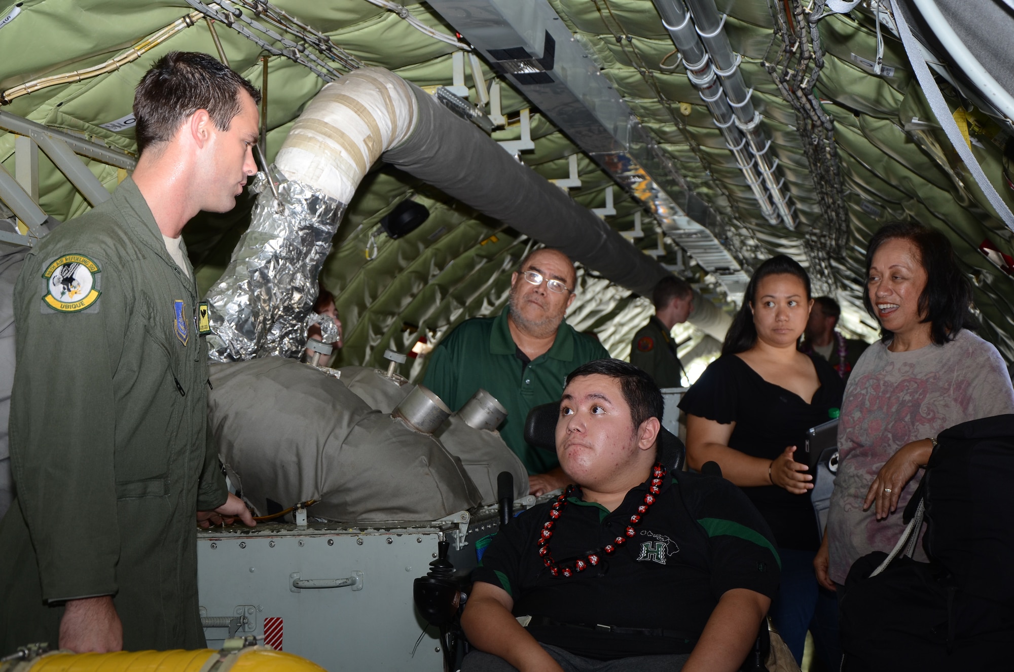 Airman 1st Class Kenneth D. Stricker, 96th Airlift Refueling Squadron boom operator, left, explains to Damon Hall-Kaneakua, center, and his family members how the auxiliary power unit on a KC-135 Stratotanker starts the jet engines with bleed air, while aboard a KC-135 on the flightline at Joint Base Pearl Harbor-Hickam, Hawaii, May 3, 2013. The Pilot for a Day program focuses on children who have serious or chronic conditions, with the goal of giving each child a special day and a break from whatever challenges they may face. (U.S. Air Force photo/Tech. Sgt. Phyllis E. Keith)