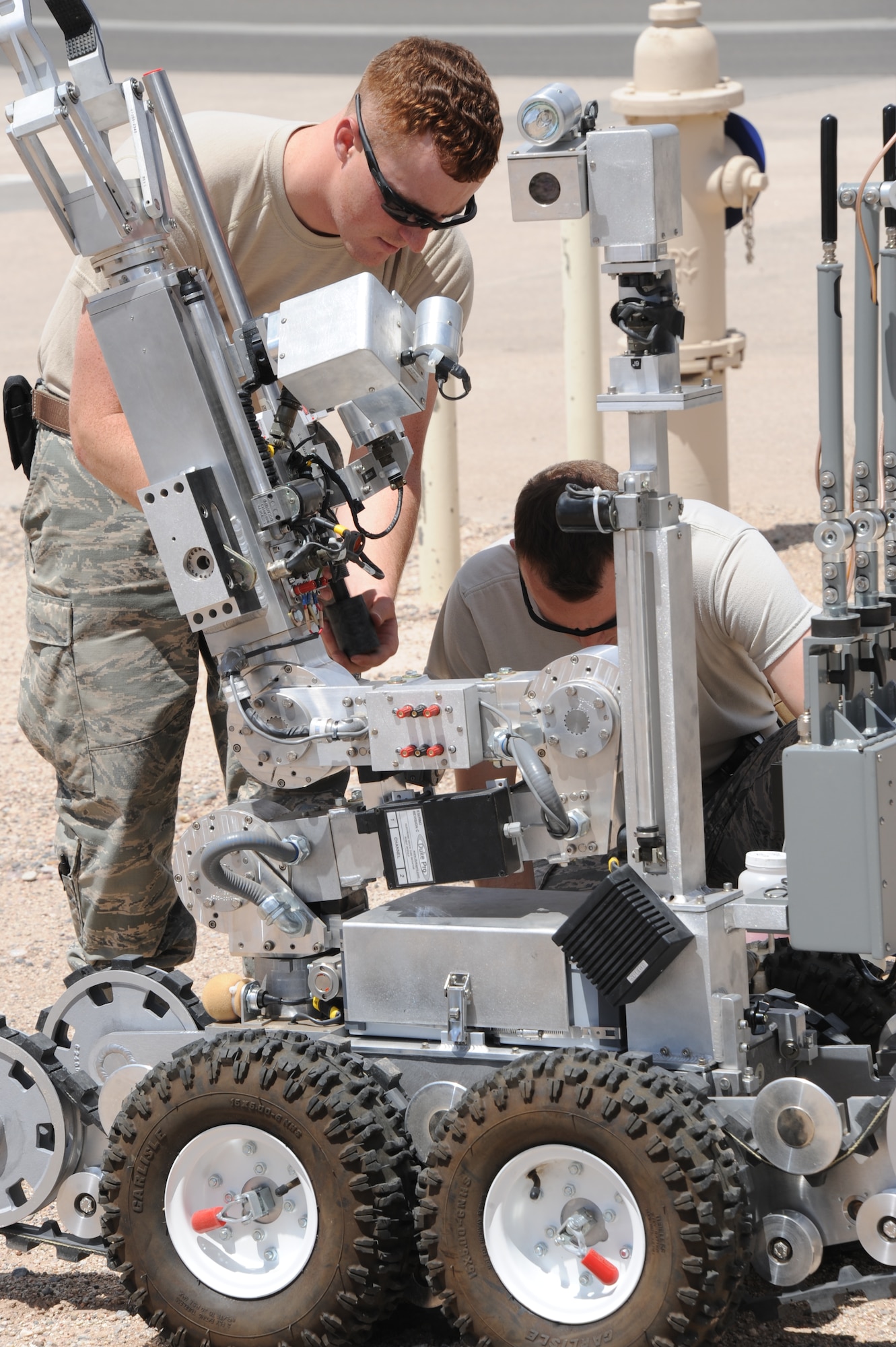 Staff Sgt. Leon Medows, left, and Airman 1st Class Davyd Fitzhugh of the 377th Explosive Ordnance Disposal Flight at Kirtland AFB conduct a pre-mission combat check of the EOD remote-controlled robot for a training exercise April 30. 