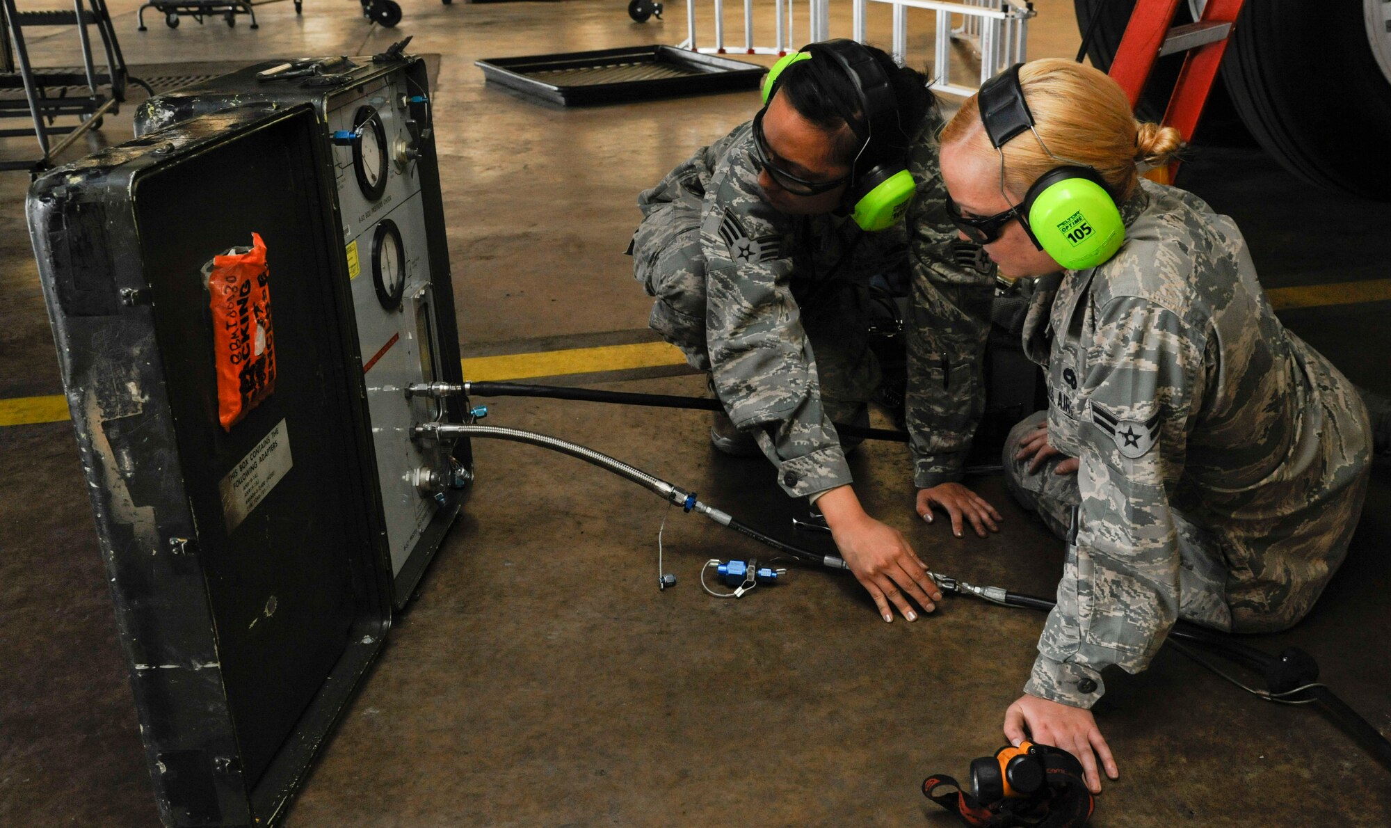 Senior Airman Kristin Saenz and Airman 1st Class Kristen McConnell, 2nd Maintenance Squadron Accessories flight electrical and environmental section, conduct a missile leak check on a B-52H Stratofortress on Barksdale Air Force Base, La., April 26, 2013. The check makes sure the weapon systems of the aircraft work properly and that any fittings are properly sealed. (U.S. Air Force photo/Airman 1st Class Andrew Moua) 