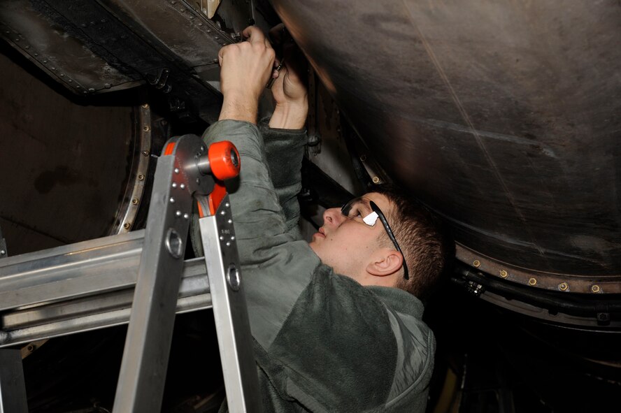 Airman 1st Class Kyle Gallegos, 2nd Maintenance Squadron crew chief, installs a fire wall panel on the engines of a B-52H Stratofortress during a phase inspection on Barksdale Air Force Base, La., April 26, 2013. The panel protects the bleed air and electrical systems case of engine fire or hostile actions. (U.S. Air Force photo/Airman 1st Class Andrew Moua)