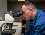 Tech. Sgt. Edgar Ferreira, 47th Medical Support Squadron NCO in charge of laboratory operations, looks through a microscope at Laughlin Air Force Base, Texas, May 8, 2013. The American Nurses Association and Laughlin have declared the week of May 6 through 12 as National Nurses and Technicians Week to celebrate the safe, high quality care provided to patients. (U.S. Air Force photo/Airman 1st Class John D. Partlow)