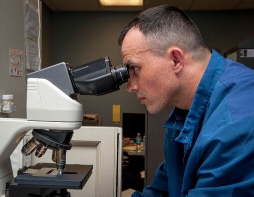 Tech. Sgt. Edgar Ferreira, 47th Medical Support Squadron NCO in charge of laboratory operations, looks through a microscope at Laughlin Air Force Base, Texas, May 8, 2013. The American Nurses Association and Laughlin have declared the week of May 6 through 12 as National Nurses and Technicians Week to celebrate the safe, high quality care provided to patients. (U.S. Air Force photo/Airman 1st Class John D. Partlow)