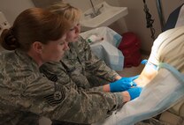 Tech. Sgt. Jaimy Gennero, 47th MDOS chief of flight medicine, mentors an Airman during an IV procedure at Laughlin Air Force Base, Texas, May 8, 2013. Gennero oversees the flight medical operations at Laughlin and is the head medical qualifier for the personnel reliability program. (U.S. Air Force photo/Airman 1st Class John D. Partlow)