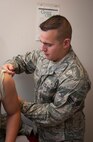 Senior Airman Daniel Lee, 47th Medical Operations Squadron medical technician, administers a vaccine to a patient May 8, 2013, at Laughlin Air Force Base, Texas. Lee gives deployment specific immunizations, such as typhoid fever or small pox, to ensure that each person is immune and ready for the deployment. (U.S. Air Force photo/Airman 1st Class John D. Partlow)