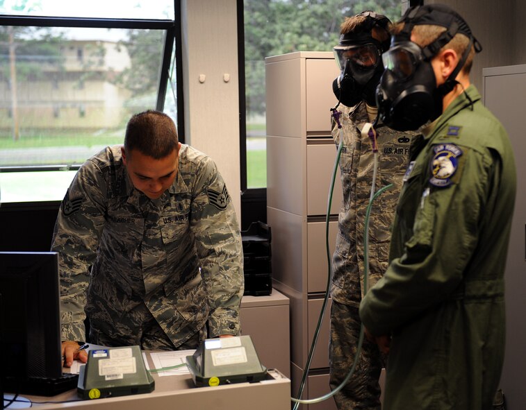 Staff Sgt. Shawn Gallagher, 2nd Aerospace Medical Squadron, reads information off a photocount plus machine during a gas mask fit test on Barksdale Air Force Base, La., May 9, 2013. During the test, a photocount plus machine measures the particle readings from the air in the room and compares it to the air found in the gas masks to ensure the masks are sealed properly. Gas mask fit tests, which are held every Thursday from 8 to 11 a.m. at Bio-Environmental Engineering, ensure Barksdale Airmen have the correct gas mask size to protect them from chemical and biological warfare agents. (U.S. Air Force photo/Airman 1st Class Benjamin Gonsier)