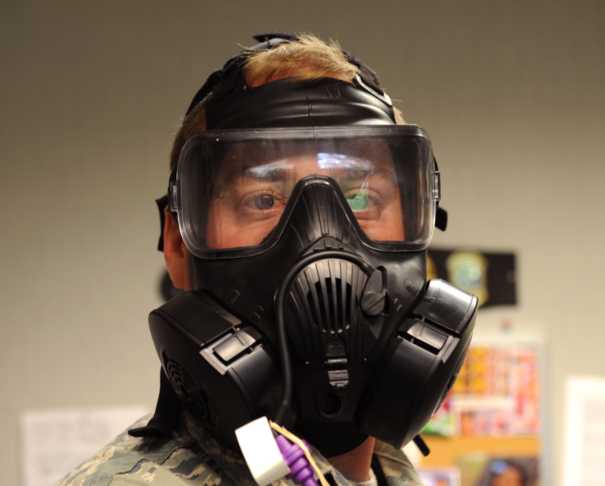 Staff Sgt. Bryan Farley, 96th Aircraft Maintenance Unit Electrical and Environmental Shop, performs a breathing exercise during a gas mask fit test on Barksdale Air Force Base, La., May 9, 2013. Barksdale personnel perform a number of breathing exercises to ensure they have the correct gas mask size and that there is no break in the seal. (U.S. Air Force photo/Airman 1st Class Benjamin Gonsier)

