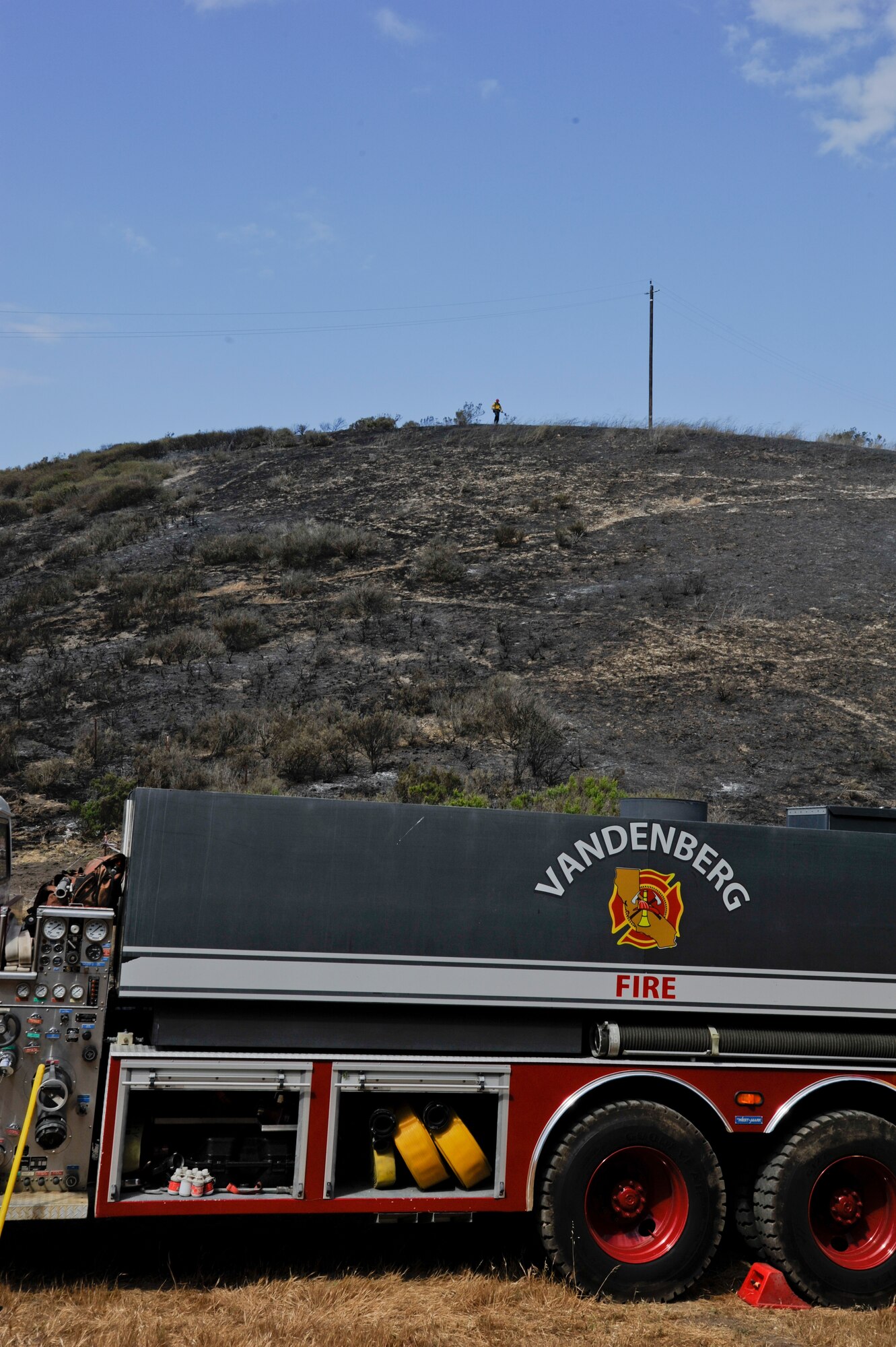 VANDENBERG AIR FORCE BASE, Calif. – A Team V firefighter stands on a charred hilltop during the containment of a fire on Highway 1 here Wednesday, May 9, 2013. Vandenberg firefighters were the first responders to the 10 acre fire and, with the help of the Santa Barbara County Fire Department and the U.S. Forest Service, contained the fire in two hours. (U.S. Air Force photo/Senior Airman Lael Huss)