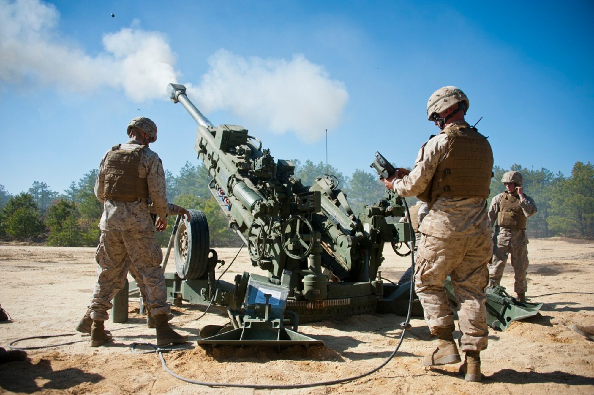 Marines from Golf Battery 3rd Battalion, 14th Marine Regiment, conduct artillery training May 4, 2013, on the Joint Base McGuire-Dix-Lakehurst ranges. The unit conducted 155 mm artillery training using their primary weapon system, M777A2 howitzer. This training is essential and helps to ensure the readiness of America's fighting force. (U.S. Air Force photo by Staff Sgt. David Carbajal/Released)