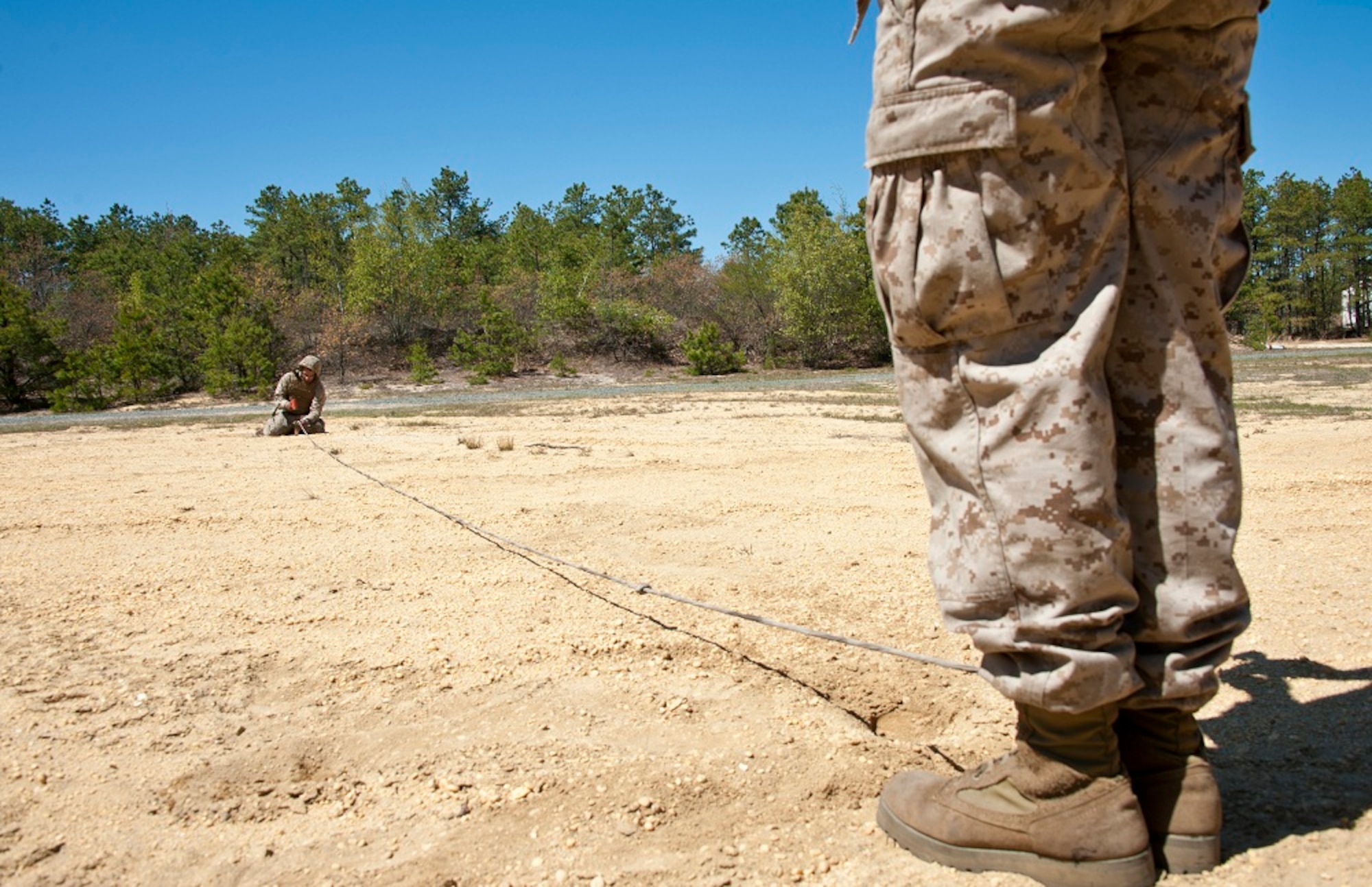 Marines from Golf Battery 3rd Battalion, 14th Marine Regiment, set the line of fire for the M777A2 howitzer during artillery training May 4, 2013, on the Joint Base McGuire-Dix-Lakehurst ranges. The lines of fire are used to line up the M777A2 howitzer to ensure the most accurate firing. The 3rd Battalion, 14th Marine Regiment is a reserve artillery battalion comprised of four firing batteries and a headquarters battery. (U.S. Air Force photo by Staff Sgt. David Carbajal/Released)