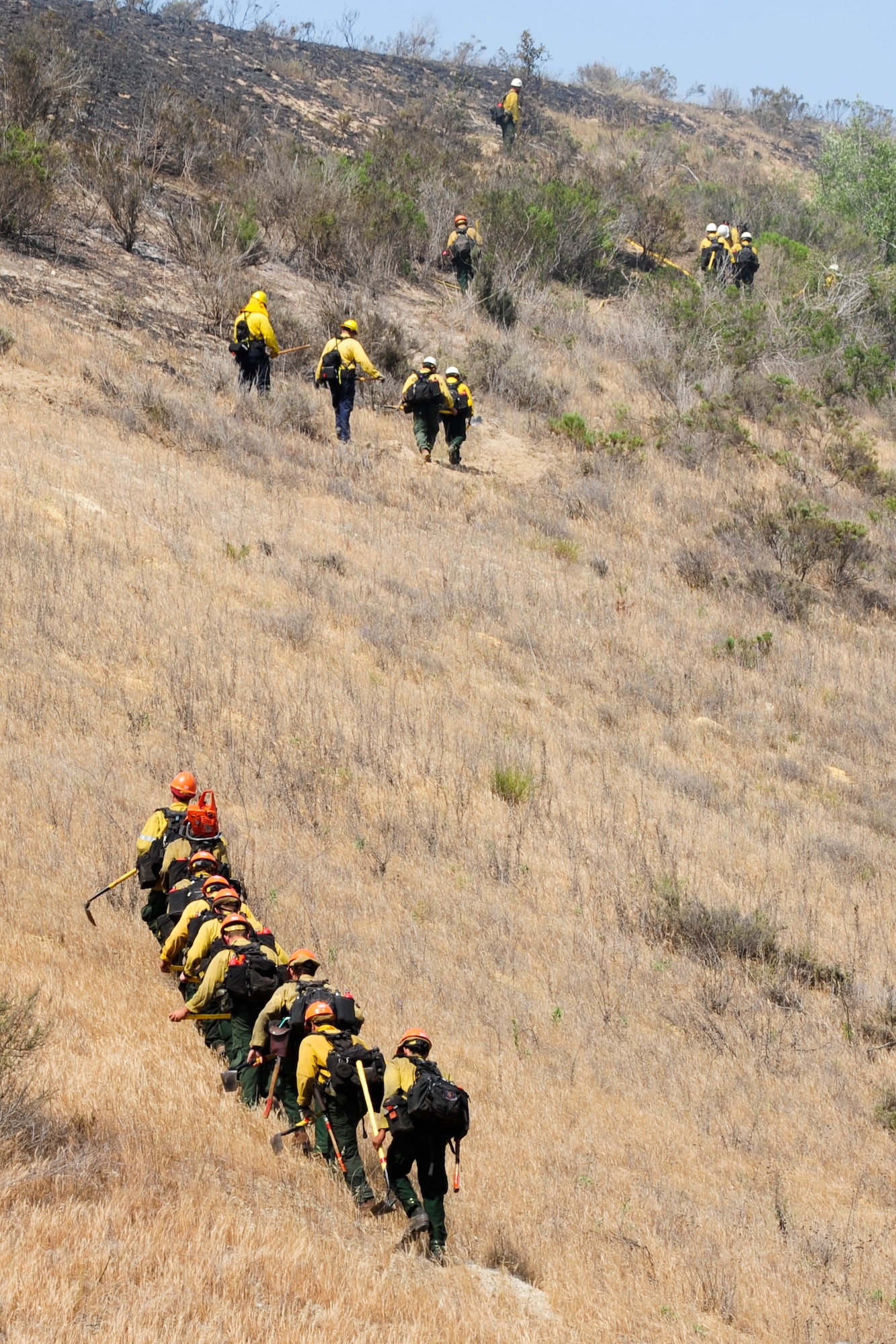 VANDENBERG AIR FORCE BASE, Calif. – Members from the Vandenberg Fire Department, Santa Barbara County Fire Department, and Forest Service respond to a fire on Highway 1 here Wednesday, May 9, 2013. The seven to 10-acre fire located a half-mile north of San Antonio Road West was contained within two hours. (U.S. Air Force photo/Airman Yvonne Morales) 