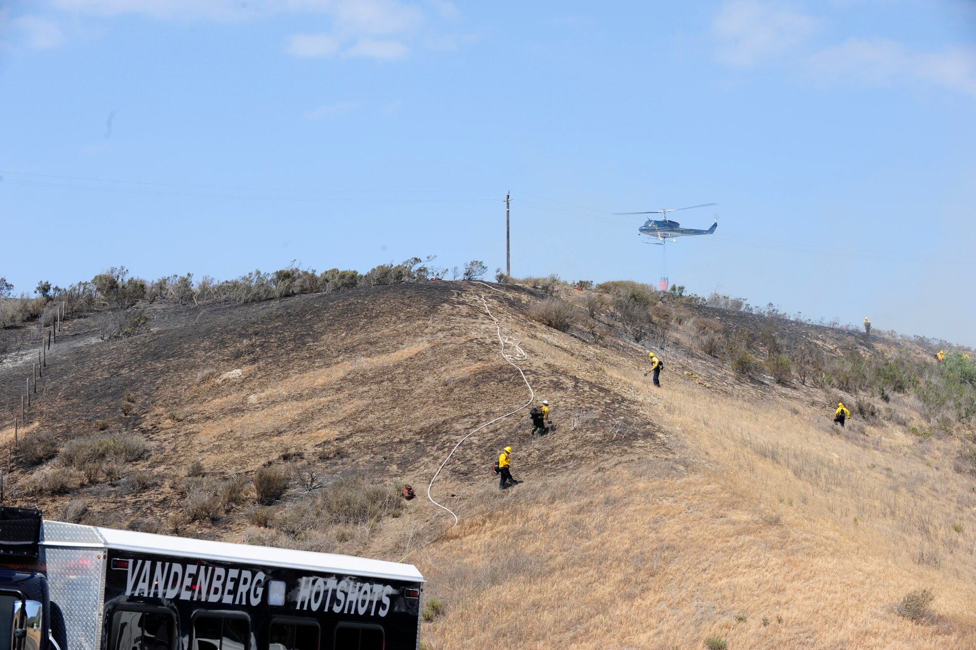 VANDENBERG AIR FORCE BASE, Calif. – Members from the Vandenberg Fire Department, Santa Barbara County Fire Department, and Forest Service respond to a fire on Highway 1 here Wednesday, May 9, 2013. The seven to 10-acre fire located a half-mile north of San Antonio Road West was contained within two hours. (U.S. Air Force photo/Airman Yvonne Morales) 