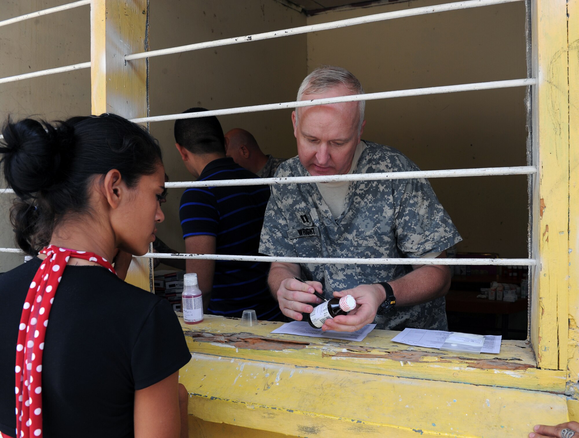 U.S. Army Capt. Philip Wright, Joint Task Force-Bravo Pharmacist, explains how to take the medication to a patient during a  Medical Readiness exercise, May 6. Joint Task force-Bravo partnered with Honduran Ministry of Health and Honduran military personnel, to provide medical services to more than 500 Cuesta de la Virgen community members. (Photo by Martin Chahin)