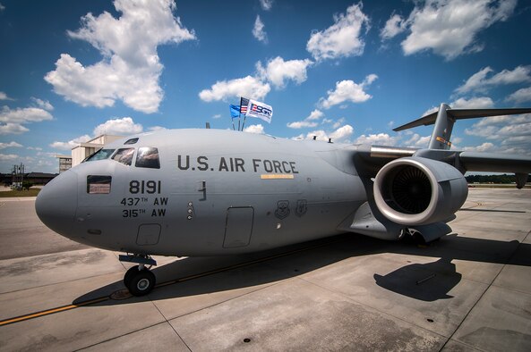 A Charleston C-17 Globemaster III displays the Employer Support of the Guard and Reserve flag along with the U.S. Flag and Air Force flag on the flight line at Joint Base Charleston, S.C. The 437th Airlift Wing shares the jets with the 315th Airlift Wing to help Team Charleston accomplish the Air Force's rapid deployment and global reach cababilities. (U.S. Air Force Reserve photo by Michael Dukes)