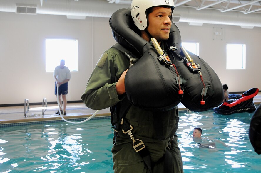 Maj. Rich Meziere, a pilot from the 190th Fighter Squadron, prepares to be pulled into the water during water survival training, May 5, at the Idaho State Police Training Facility in Meridian, Idaho. (Air National Guard photo by Tech. Sgt. Becky Vanshur)