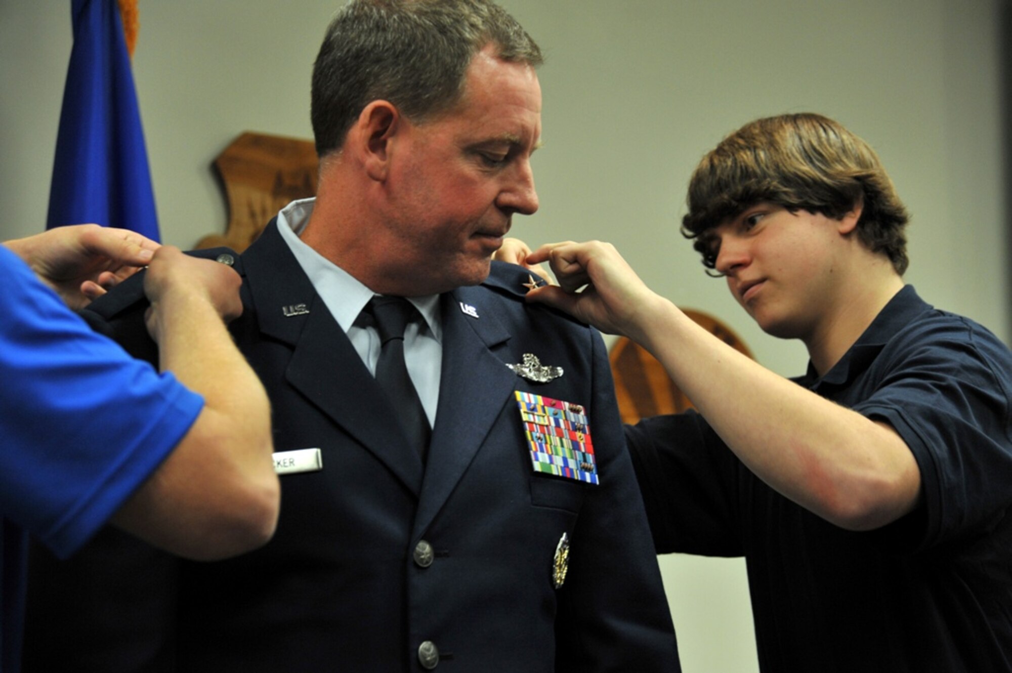 LAS VEGAS, Nev. -- The sons of Col. James Hecker, prior 432nd Wing and 432nd Air Expeditionary Wing Commander, pin on his first star during a frocking ceremony May 3, 2013. Hecker was frocked to the rank of brigadier general after relinquishing command of the 432nd Wing and 432nd AEW, in preparation for taking command of the 18th Fighter Wing at Kadena Air Base, Japan. (U.S. Air Force photo by Senior Airman A.K./Released)