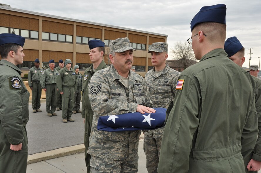 Niagara Falls Reserve Station 914th Airlift Wing personnel participate in the ceremonial folding of the flag, April 7, 2013 Niagara Falls, NY. In the Armed Forces of the United States, at the ceremony of retreat the flag is lowered, folded in a triangle fold and kept under watch throughout the night as a tribute to our nation's honored dead. (U.S. Air Force photo by Staff Sgt Stephanie Clark) 