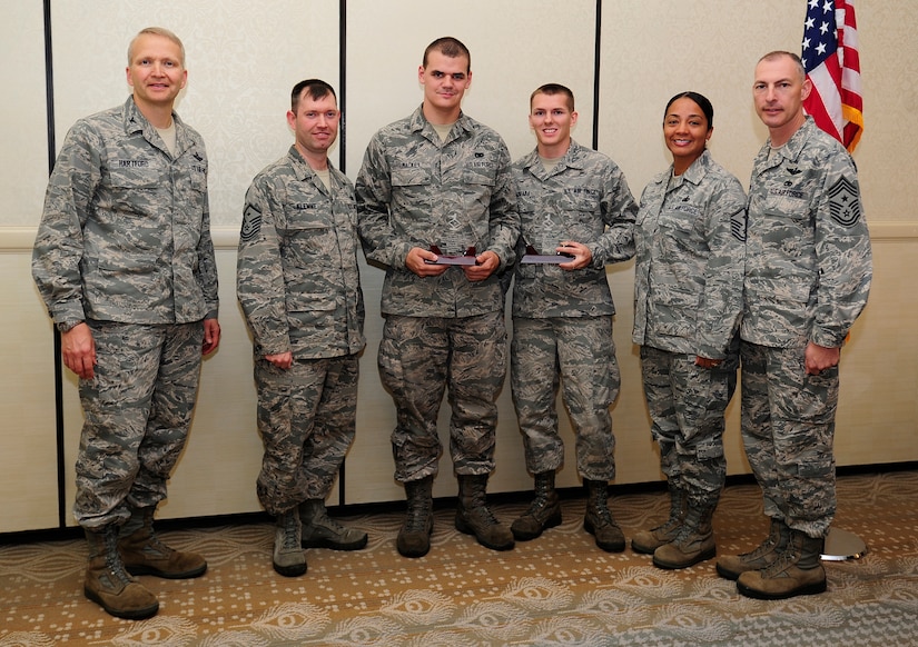 Col. Darren Hartford 437th Airlift Wing commander (left), and Chief Master Sgt. Larry Williams, 437th AW command chief (right), recognize May's Diamond Sharp winners May 7, 2013, at the Charleston Club at Joint Base Charleston – Air Base, S.C. The Diamond Sharp recipients are (third and fourth from left) Airman 1st Class John Mackey, 437th Aerial Port Squadron air transportation apprentice and Senior Airman Brian Hadraba, 437th Maintenance Squadron crew chief. Pictured with the Diamond Sharp winners are Master Sgt. Jeremy Klemme, 437th APS first sergeant and Master Sgt. Jadirra Walls, 437th MXS first sergeant. Diamond Sharp awardees are Airmen chosen by their first sergeants for their excellent performance. Not pictured here but also a recipient of this month's Diamond Sharp award is Airman 1st Class Briyana Johnson, 15th Airlift Squadron aviation resource management apprentice. (U.S. Air Force photo/Staff Sgt. Rasheen Douglas)