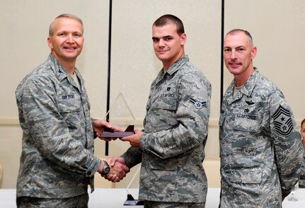 Col. Darren Hartford, 437th Airlift Wing commander, and Chief Master Sgt. Larry Williams, 437th AW command chief, congratulate Airman 1st Class John Mackey, 437th Aerial Port Squadron air transportation apprentice, as a Diamond Sharp award winner during a ceremony May 7, 2013, at the Charleston Club at Joint Base Charleston - Air Base, S.C. Diamond Sharp awardees are Airmen chosen by their first sergeants for their excellent performance. (U.S. Air Force photo/Staff Sgt. Rasheen Douglas)
