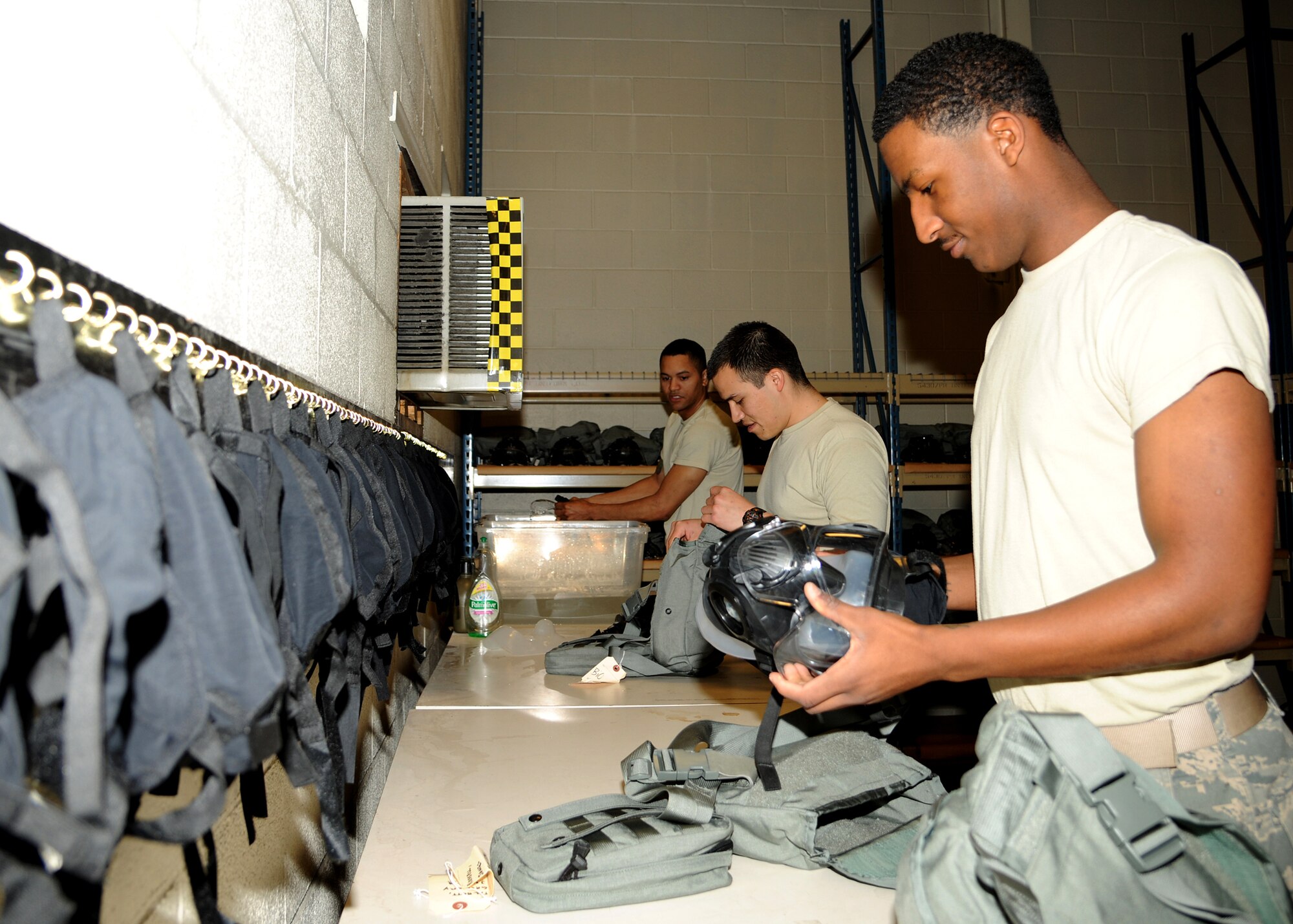 Members of the 319th Logistics Readiness Squadron individual protective equipment shop, form an assembly line dismantling and sanitizing gas masks, May 6, 2013, on Grand Forks Air Force Base, N.D. After all gas masks are cleaned, they will be placed in storage or redistributed to other military installations. (U.S. Air Force photo/Airman 1st Class Ashley Nicole Taylor)  