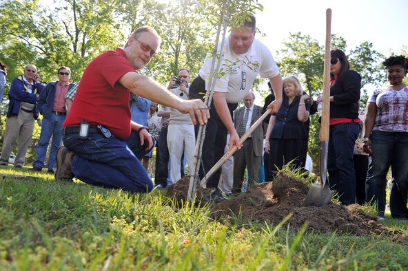 Kendall Preston, 778th Civil Engineer Squadron mechanical engineer, and Kevin Bartoe, deputy chief of Special Operations, plant a Live Oak at the tree-planting ceremony conducted at Robins. (U. S. Air Force photo by Tommie Horton/Released)