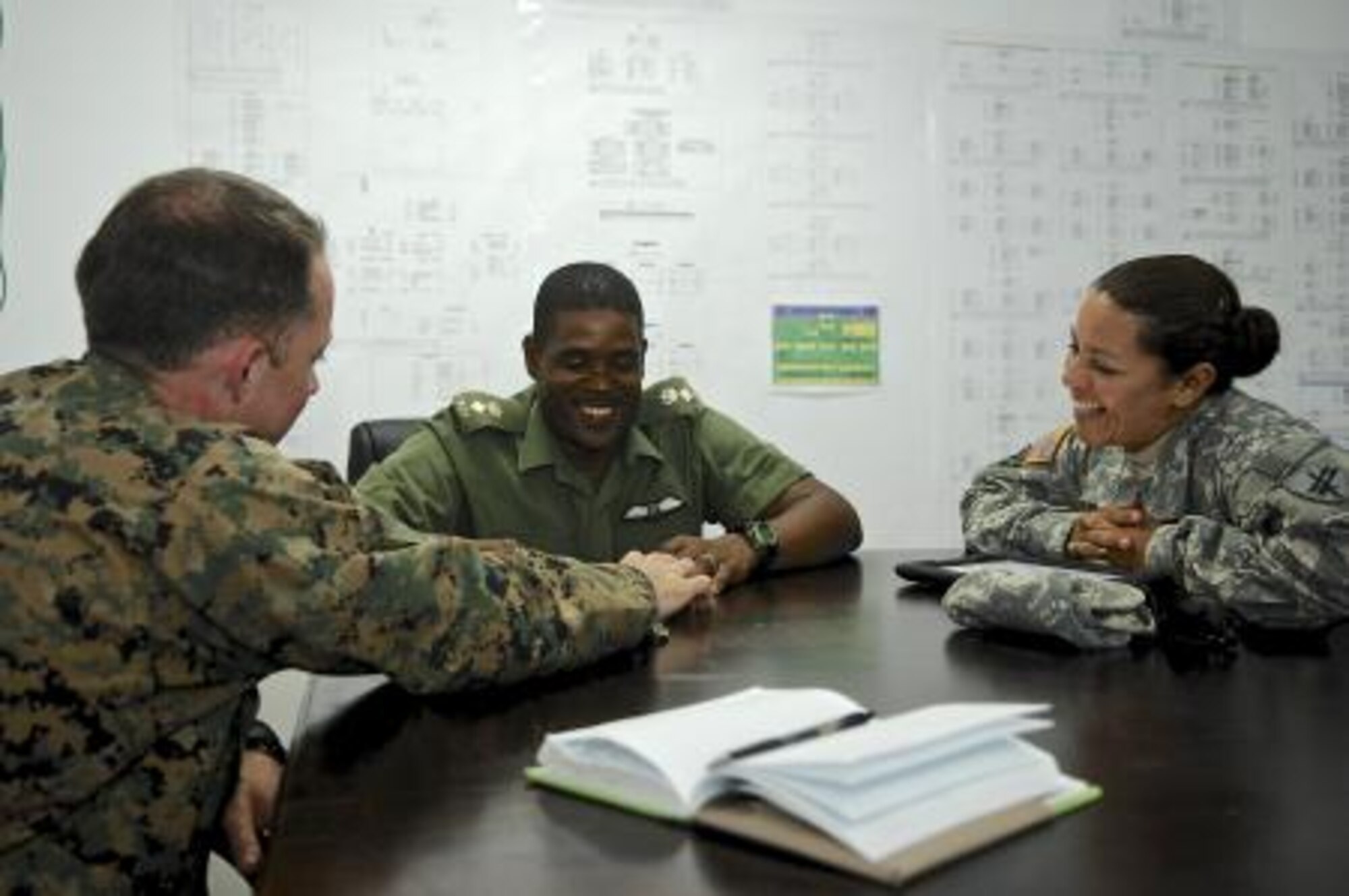 U.S. Marine Capt. Thomas Cahill, left, and U.S. Army Capt. Zulma Andrews, right, both civil affairs, share a laugh with Belize Defense Force Chief of Staff Lt. Col. Raymond Shepherd, center, during a key leader engagement May 6, 2013, at Price Barracks, Belize. The civil affairs team meets with key leaders and local communities to assess host-nation capabilities as part of an exercise known as New Horizons. New Horizons is a training exercise providing medical and dental treatment as well as constructs needed structures, such as classrooms, throughout Belize. It gives U.S., Belizean and Canadian service members the opportunity to train side-by-side in an exercise setting in order to be prepared to meet future challenges. (U.S. Air Force photo/Master Sgt. James Law)
