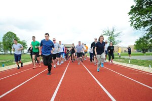 Lieutenant Cololnel, Mark Cucuzzella,  Air Force Marathon chief medical consultant and Brenda Shrank, 2013 JBA half-marathon winner, lead Team Andrews members in a practice run at an Efficient Runners Seminar May 7-8, 2013, at the East Fitness Center here. The Health and Wellness Center sponsored the event. (U.S. Air Force photo/Staff Sgt. Amber Russell)