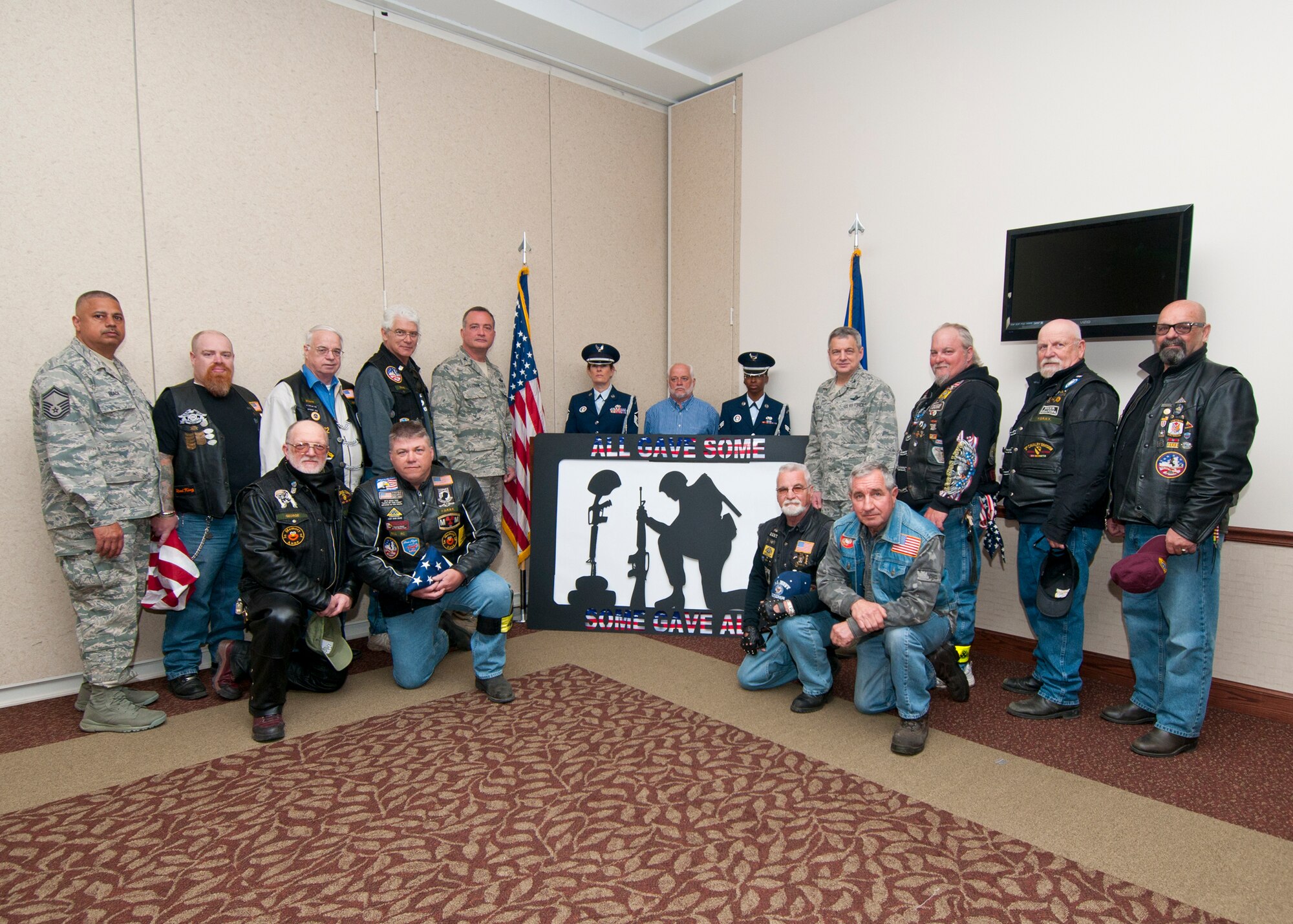 Members of the 914th Airlift Wing accept a sculpture donated by the local chapter of the Patriot Riders, May 5, 2013, Niagara Falls Air Reserve Station, N.Y. The piece titled “Never Forget Silhouette” was created by a Vietnam Veteran, Dan DeCrow to honor the War Dead and Veterans from World War One to the present. This display will be be added to the Heritage Room in the NFARS Community Activity Center. (U.S. Air Force photo by Tech. Sgt. Joseph McKee)  