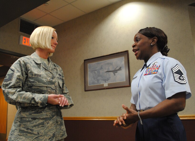 (Right) Chief Master Sgt. Vanessa Smalls-Bryant, 319th Force Support Squadron chief enlisted manager, delivers words of appreciation after presenting Master Sgt. Stephanie Rose with a Chiefs Group coin during a going away luncheon for Rose on May 1, 2013, on Grand Forks Air Force Base, N.D. Rose, a 33-year-old native of Kansas City, Mo., returned to the 319th Logistics Readiness Squadron Flight Service Center after completing her tour as program manager for the base honor guard May 2, 2013. (U.S. Air Force photo/Staff Sgt. Luis Loza Gutierrez)