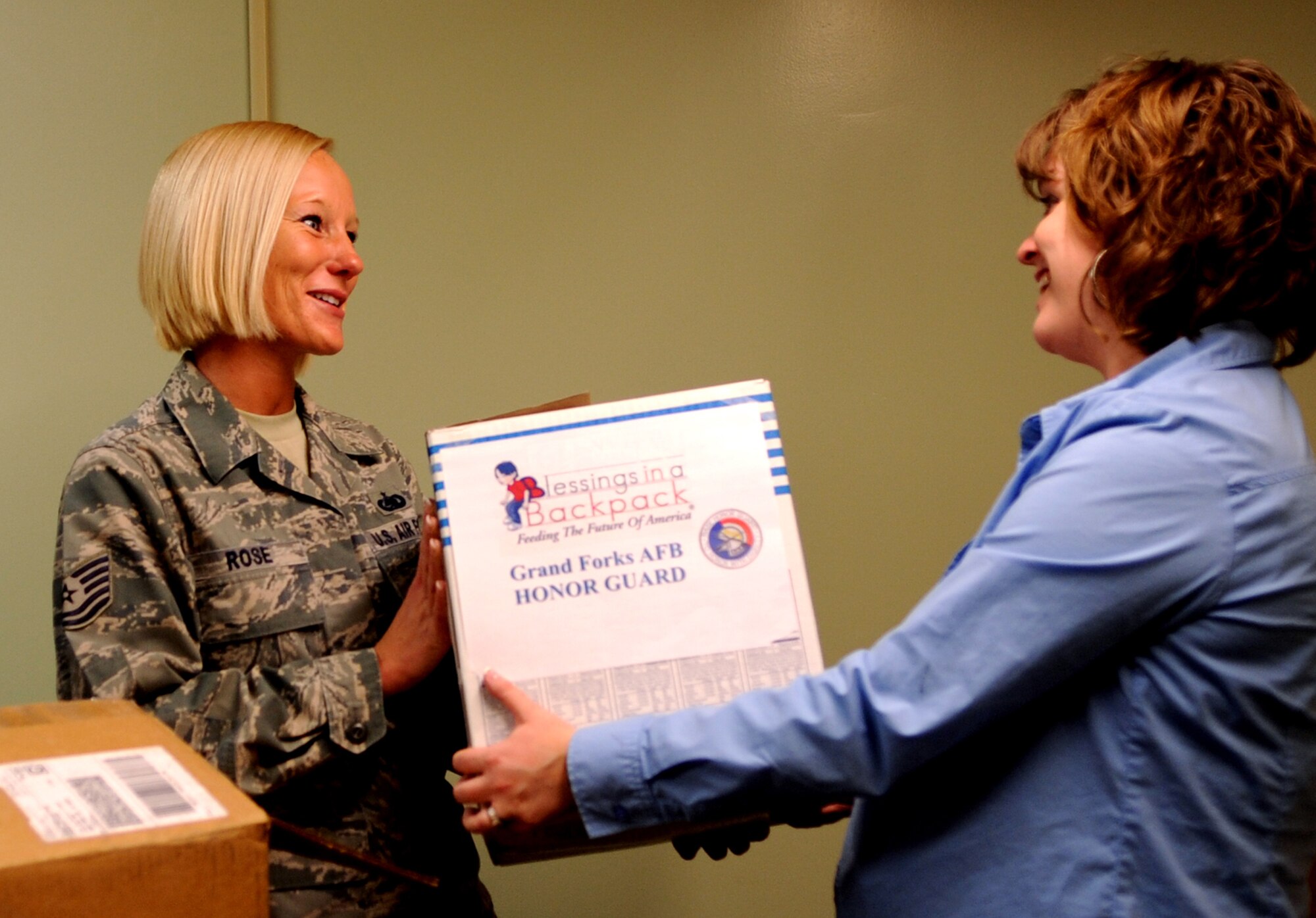Then-Tech. Sgt. Stephanie Rose, Grand Forks Air Force Base Honor Guard program manager, delivers boxes of donated food items, toiletries and school supplies to Laura McLaurin, a counselor at Sweetwater Elementary School in Devils Lake, N.D., on April 12, 2012. Rose helped establish a local chapter of the Blessings in Backpack, a charitable program designed to fight child hunger among local school children who all too often go hungry over the weekends. Master Sgt. Rose was named the base’s Warrior of the Week for the second week of May 2013. (U.S. Air Force photo/Staff Sgt. Amanda N. Grabiec)
