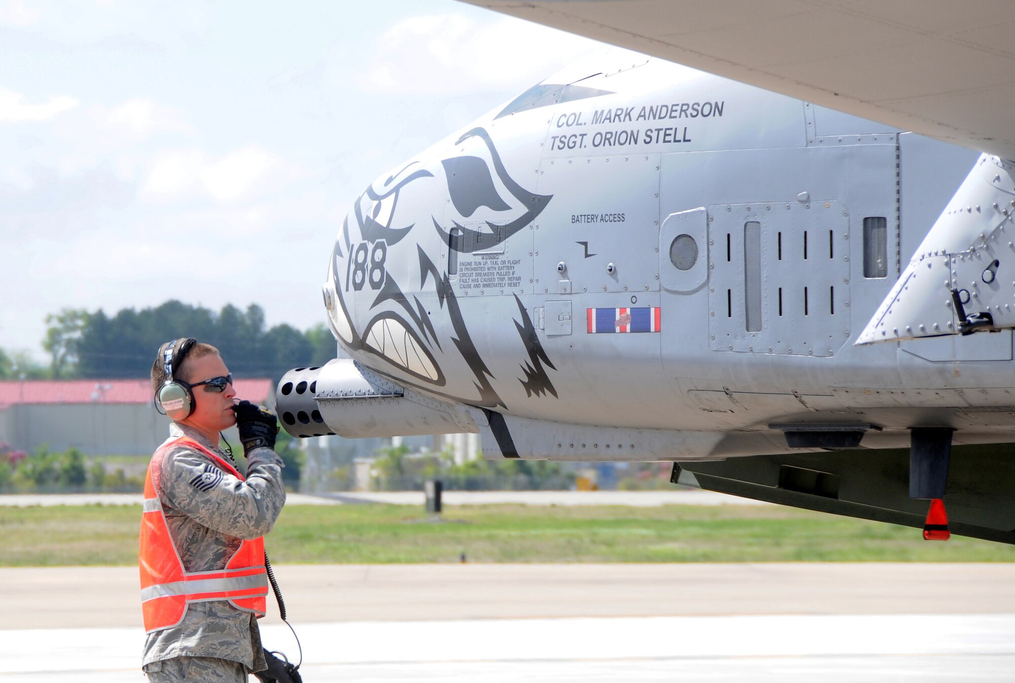 Technical Sgt. Orion Stell, a crew chief with the 188th Fighter Wing, Arkansas Air National Guard, communicates with Col. Mark Anderson after a hot pit refueling of his A-10C Thunderbolt II at Ebbing Air National Guard Base, Fort Smith, Ark.,  April 24, 2013. (U.S. Air National Guard photo by Senior Airman John Hillier/Released)