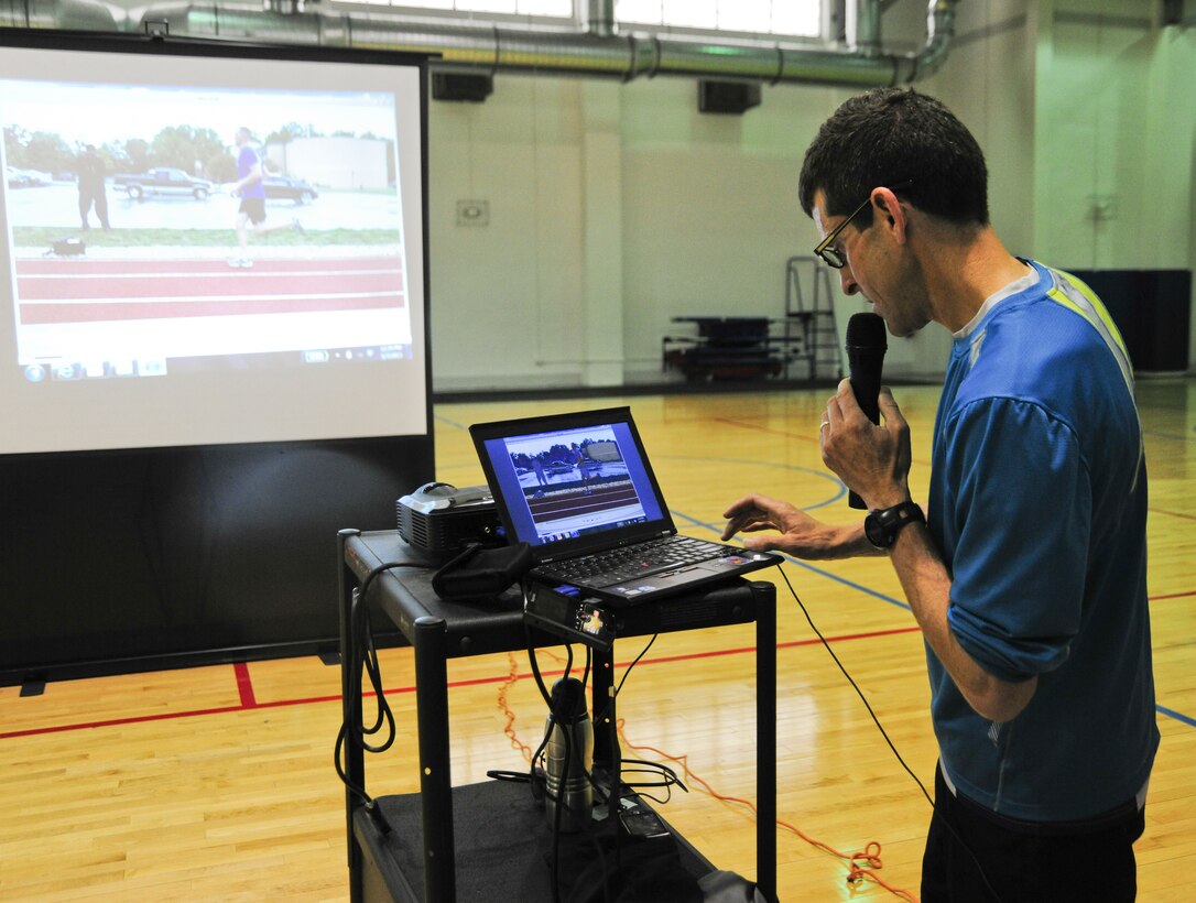 Lieutenant Colonel Mark Cucuzzella, Air Force Marathon chief medical consultant and Natural Running Center director, shows Team Andrews members a play-by-play video of themselves running at an Efficient Runners Seminar held May 7-8, 2013, at the East Fitness Center. The Health and Wellness Center sponsored the event. (U.S. Air Force photo/Staff Sgt. Amber Russell)