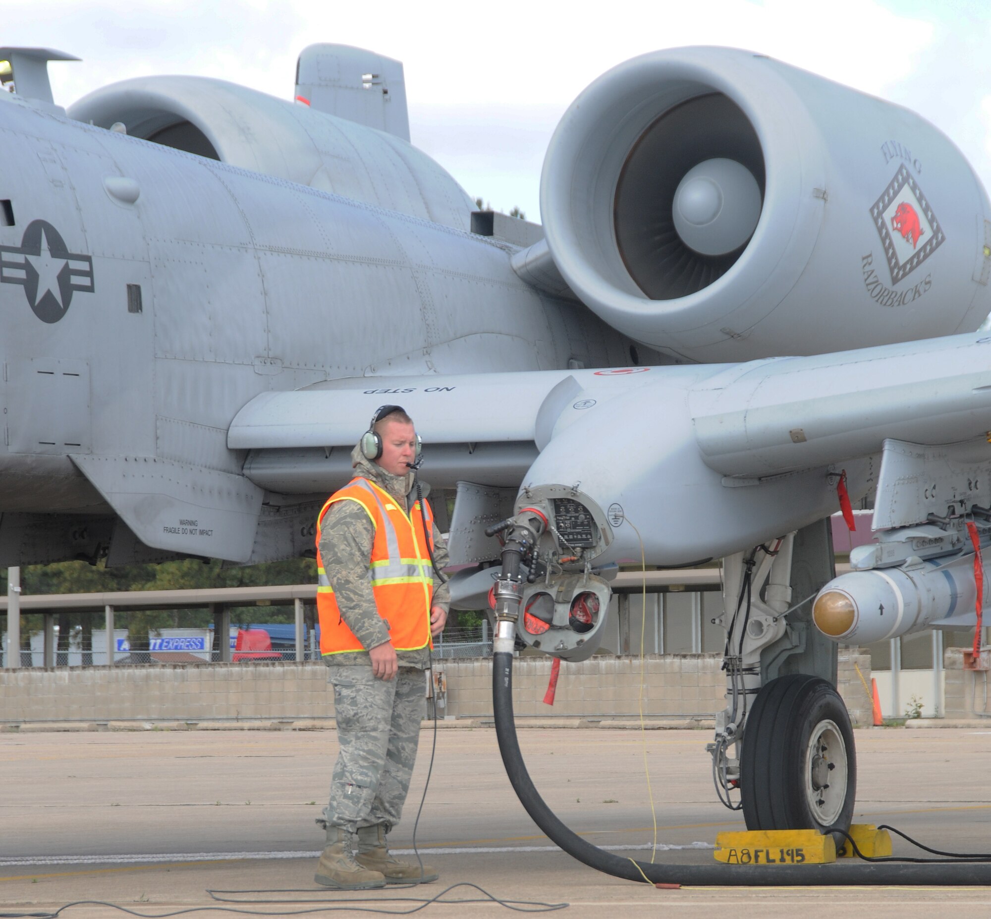 Staff Sgt. Nick Warrick of the 188th Fighter Wing, Arkansas Air National Guard, performs a hot-pit refueling of an A-10C Thunderbolt II at Ebbing Air National Guard Base, Fort Smith, Arkansas, April 24, 2013. (U.S. Air National Guard photo by Senior Airman John Hillier/188th Fighter Wing Public Affairs)