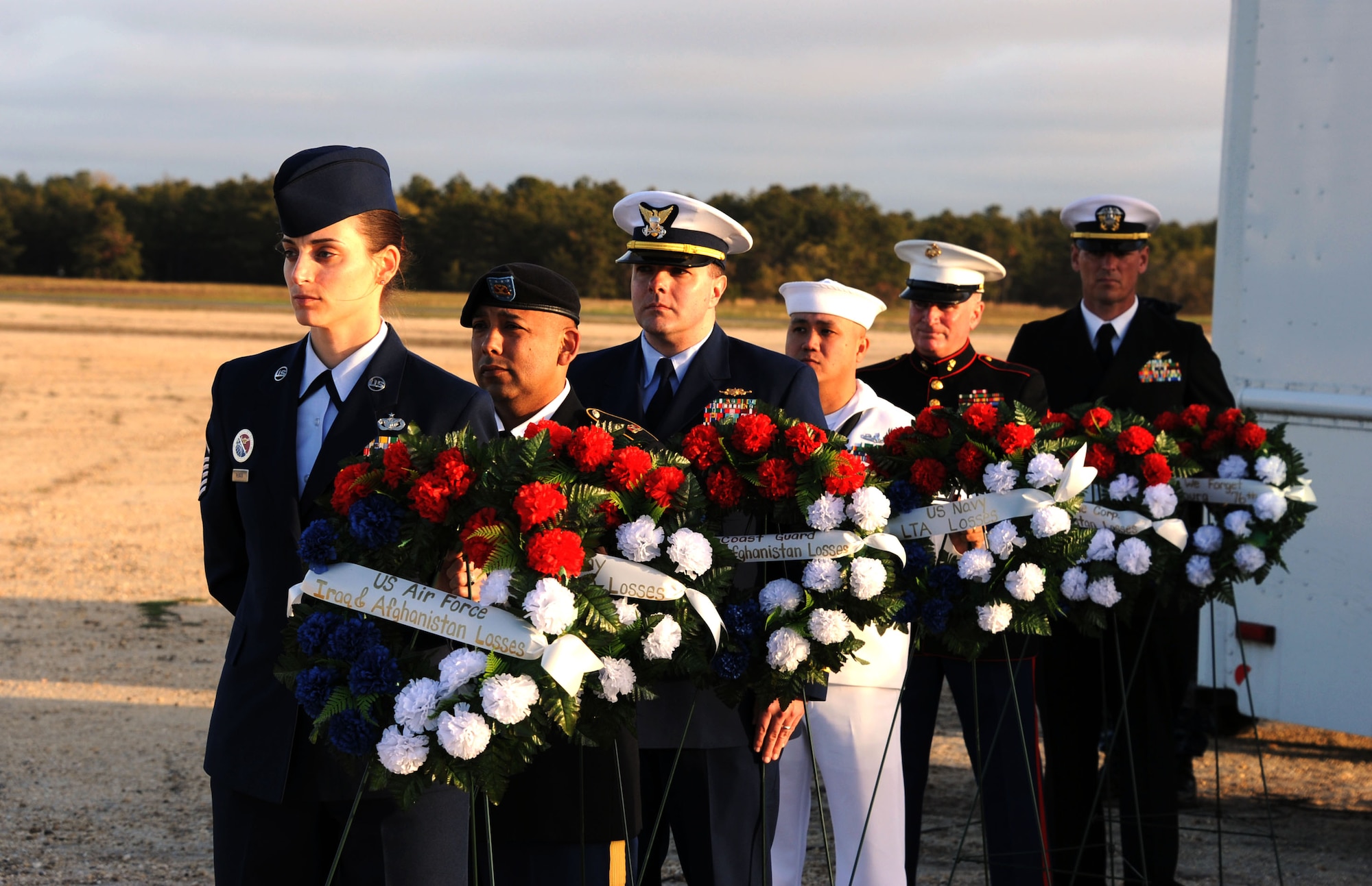 Joint Base McGuire-Dix-Lakehurst service members prepare to ceremoniously place wreaths, which represented the services members from all military branches lost during the conflicts in Iraq and Afghanistan, on the Hindenburg Memorial May 6, 2013, at JB MDL, N.J. The day marked the 76th anniversary of the Hindenburg airship disaster. Community members gathered to commemorate the 36 passengers, air and ground crew members who lost their lives in the crash May 6, 1937. (U.S. Air Force photo Airman Sean M. Crowe/Released)