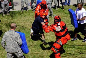 Master Sgt. Ryan Glosson, 366th Security Forces Squadron first sergeant, faces fellow Defenders wearing ‘Red Man’ suits and earned a security forces beret after completing grueling physical tasks April 16, 2013. Maj. Ryan Bodge, 366th SFS commander, said, “This isn’t as much about the beret as it is about the symbol of the beret and the people in the unit who know, love and respect you.” (U.S. Air Force photo by Master Sgt. Kevin Wallace/RELEASED)
