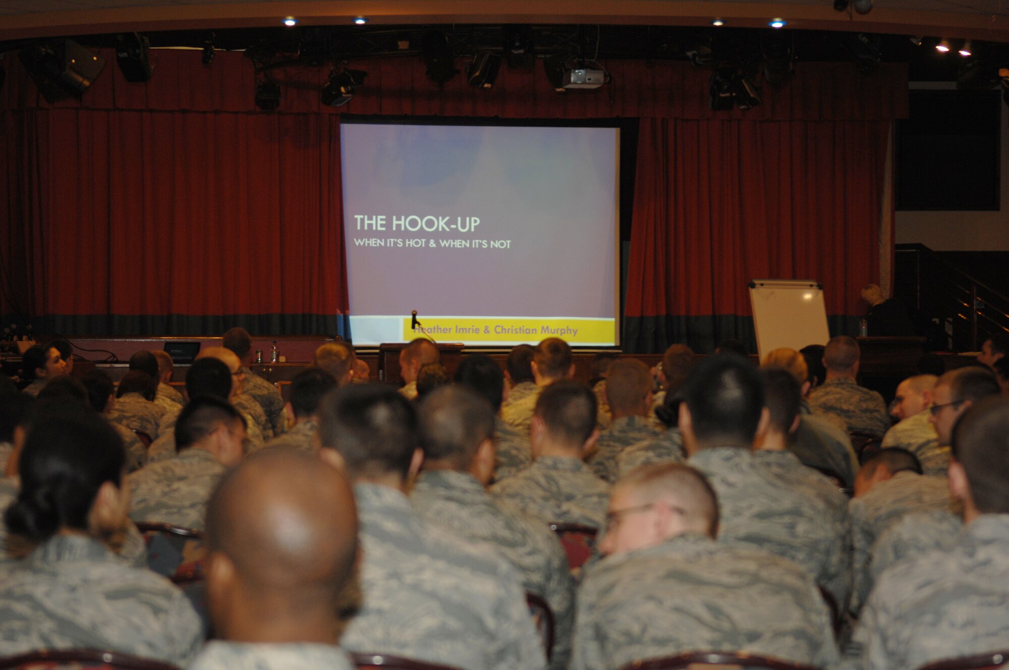 Team Mildenhall Airmen wait for the presentation “The Hook-up” to begin May 8, 2013, at the Galaxy Club on RAF Mildenhall, England. “The Hook-up” is a presentation geared toward Airmen ages 18 to 25 and it covered topics such as sexual assault and how to prevent it. (U.S. Air Force photo by Airman 1st Class Dillon Johnston/Released)