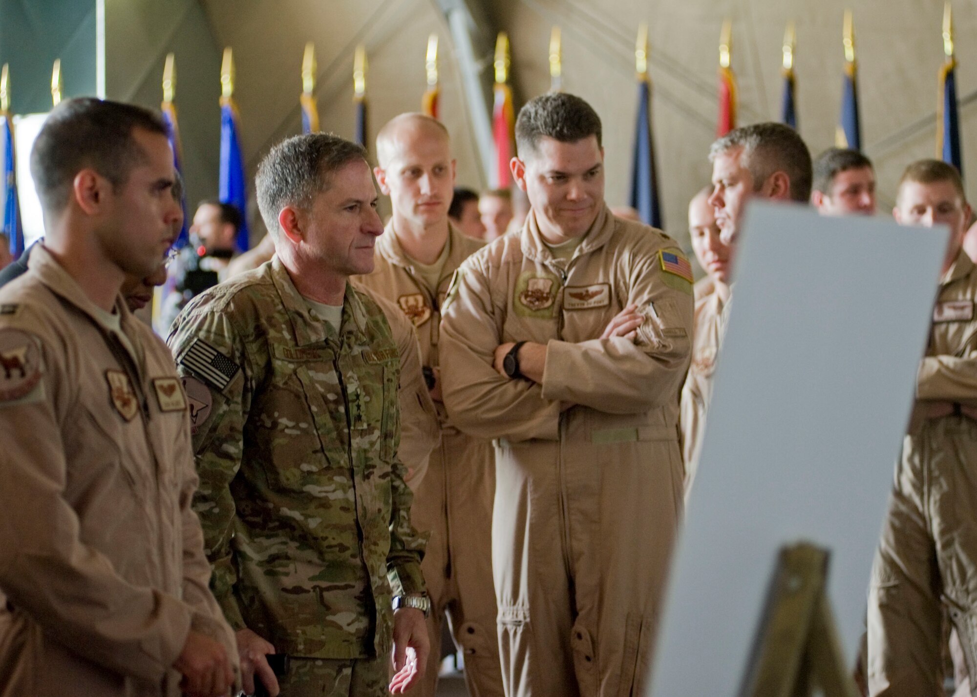 Center, Lt. Gen. David Goldfein, U.S. Air Forces Central Command commander, and 22nd Expeditionary Air Refueling Squadron Airmen view photos of the fallen crew members of Shell 77 after a memorial service held in their honor May 9, 2013, at Transit Center at Manas, Kyrgyzstan. Goldfein visited the Transit Center to pay his respects to Capt. Mark "Tyler" Voss, Capt. Victoria "Tori" Pinckney, and Tech. Sgt. Herman "Tre" Mackey III. (U.S. Air Force photo/Staff Sgt. Stephanie Rubi)