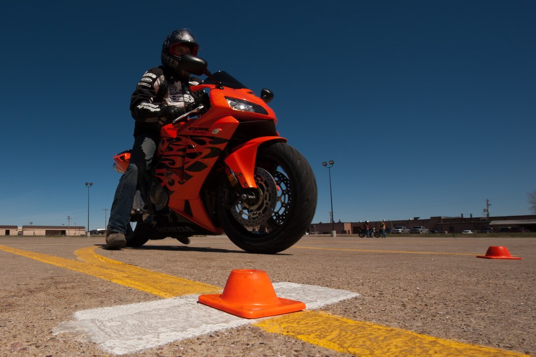Airman 1st Class Kyle Gregory, 28th Civil Engineer Squadron fire protection specialist, completes a stopping exercise during a beginners motorcycle safety course on Ellsworth Air Force Base, S.D., May 3, 2013. During the exercise, designed to test the ability for riders to stop abruptly, cyclists would speed forward then have to stop immediately when signaled to do so by the instructor. (U.S. Air Force photo by Senior Airman Kate Maurer/Released) 