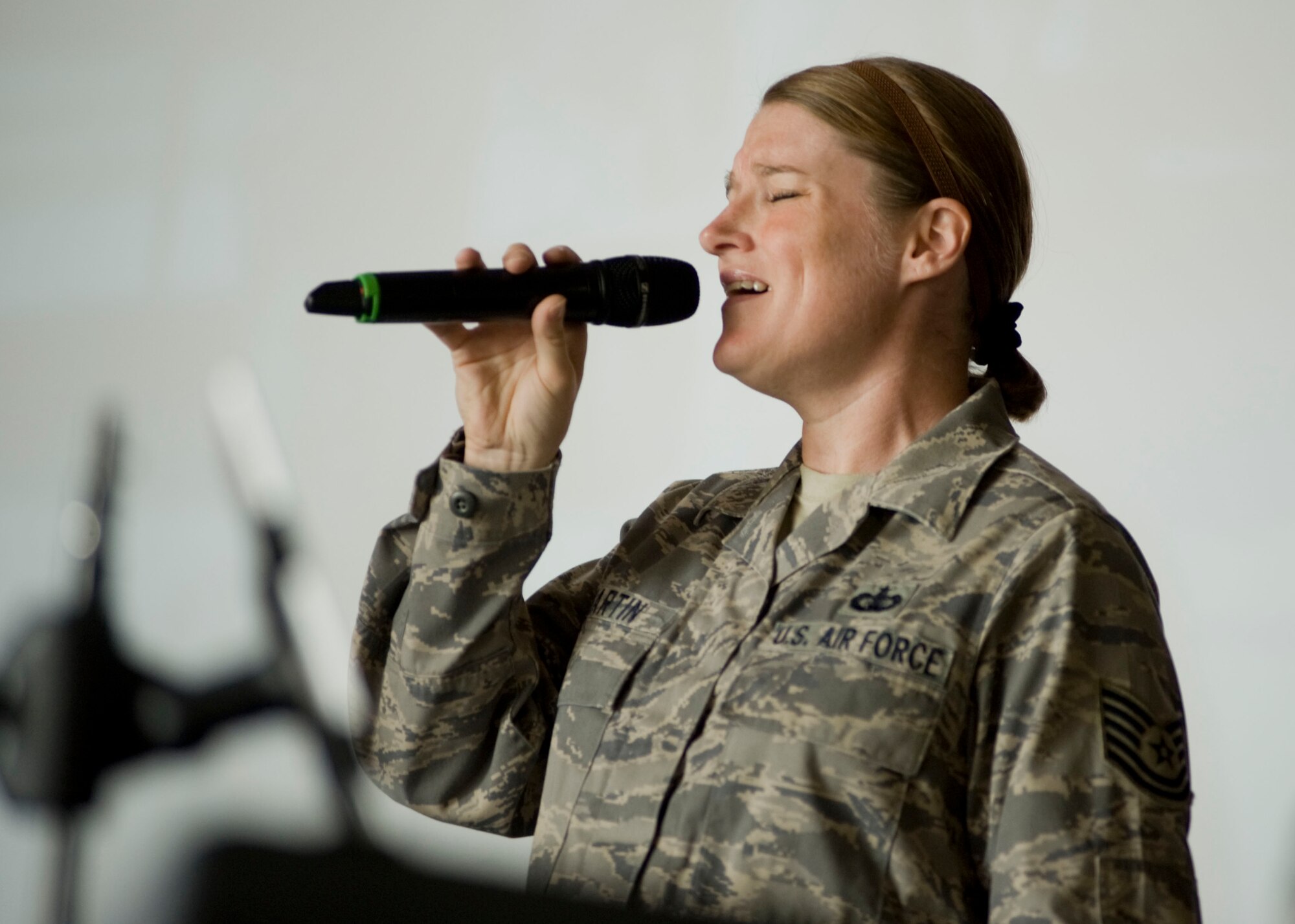 Tech. Sgt. Paige Martin, U.S. Air Forces Central Command band vocalist, sings "Amazing Grace" during a memorial service May 9, 2013, at Transit Center at Manas, Kyrgyzstan. The room filled with the voices of grieving U.S. troops as they sang along with Martin. (U.S. Air Force photo/Staff Sgt. Stephanie Rubi)