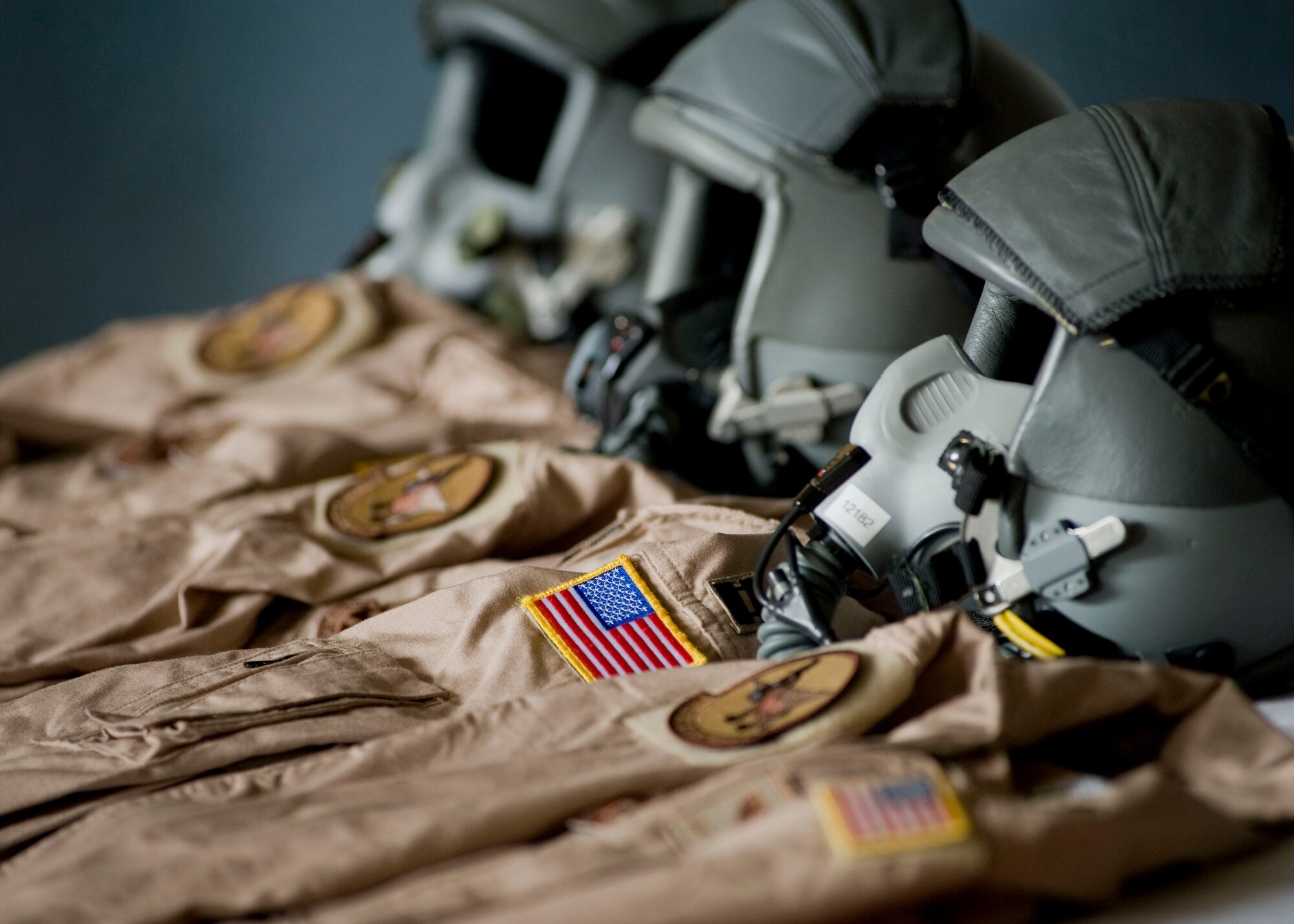 Three flight suits and aircrew oxygen masks are displayed during a memorial service May 9, 2013, at Transit Center at Manas, Kyrgyzstan.  Each suit bore the name of an Airman who perished in an aircraft accident on May 3, 2013. The crew members aboard were Capt. Mark "Tyler" Voss, Capt. Victoria "Tori" Pinckney, and Tech. Sgt. Herman "Tre" Mackey III. (U.S. Air Force photo/Staff Sgt. Stephanie Rubi)